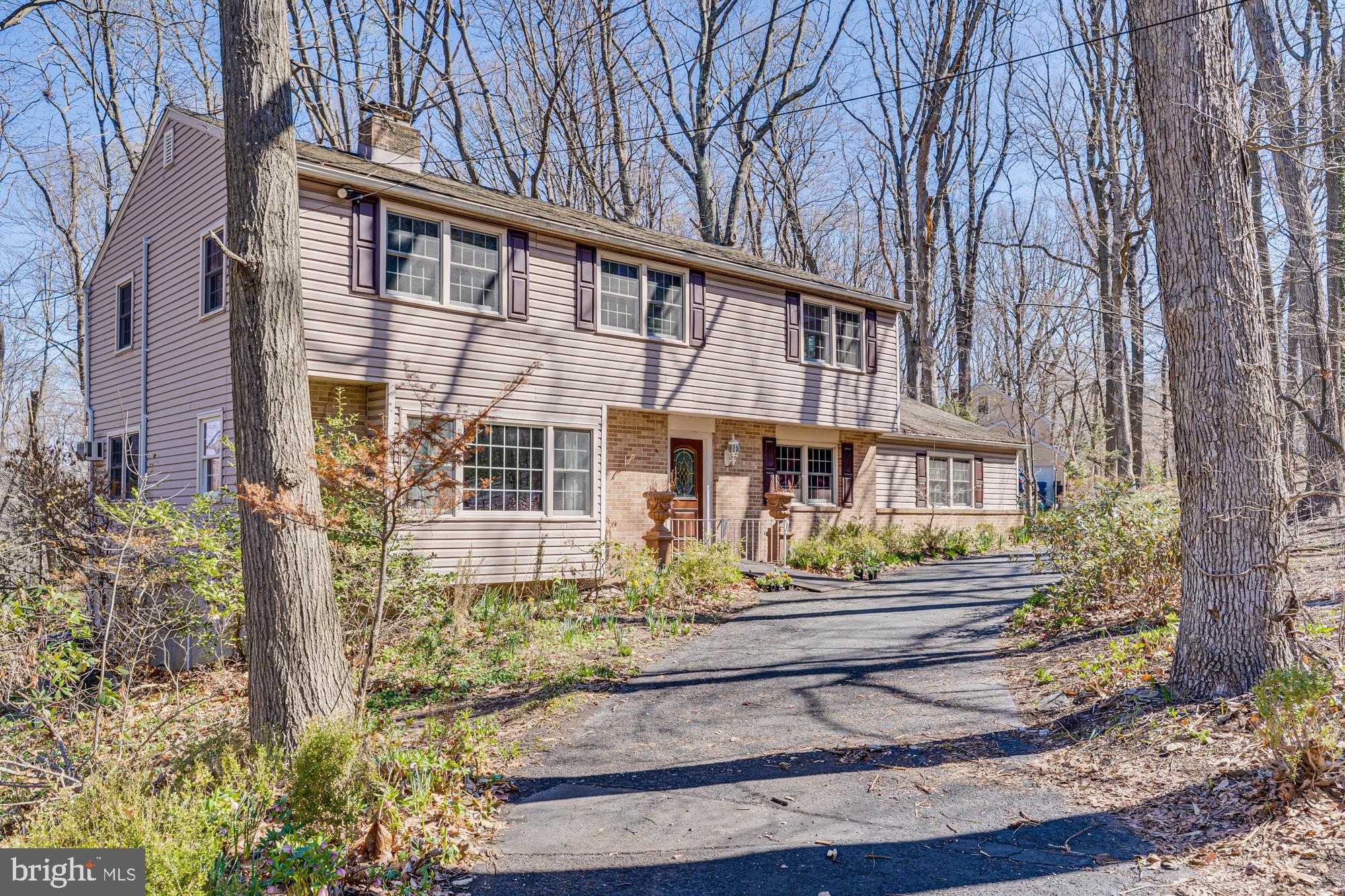 Priced to sell in as-is condition, this home is a rare opportunity for a visionary buyer. With a little imagination and some updates, it could be transformed into your own slice of paradise. Welcome to 3015 Yorkshire Road, a spacious 5-bedroom, 2.5-bathroom home brimming with potential and ready for your personal touch. Nestled on a generous lot and set back from the road, this property offers an ideal canvas to create your dream home. Step inside from the long private driveway and admire the timeless curb appeal of the brick and siding exterior. Inside, the main level is filled with natural light and offers an abundance of space to gather, relax, and entertain. The formal living room features a beautiful brick-surround wood-burning fireplace, crown molding, a detailed chair rail, and oversized windows that bathe the space in light. The formal dining room continues the traditional details, creating a seamless flow into the spacious kitchen—complete with updated appliances, solid wood cabinetry, and plenty of room for culinary creativity. The cozy family room offers a second wood-burning fireplace, hardwood flooring, crown molding, and a convenient half bath—perfect for casual evenings at home. Also on the main floor is a dedicated laundry room with built-in cabinetry and access to the two-car garage—adding convenience and functionality. Upstairs, you’ll find five generously sized bedrooms and two full bathrooms. The primary suite features wall-to-wall carpeting, a walk-in closet plus an additional closet, and a private ensuite with a stall shower. Three of the remaining bedrooms boast hardwood flooring, while the fifth is carpeted with potential hardwood underneath. A large hall bath with a jetted tub and separate stall shower serves the additional bedrooms. The partially finished walk-out basement spans an impressive 1,000 square feet and includes multiple rooms, offering endless possibilities—whether you envision a second family room, a home gym, an office, or all three, with storage to spare. Outside, the expansive backyard is surrounded by mature trees and greenery, offering privacy and a tranquil setting. Located just minutes from Route 202 and close to all the shopping, dining, coffee shops, and cultural attractions that Doylestown has to offer, this home is a rare find. Don't miss this opportunity—schedule your private tour today!