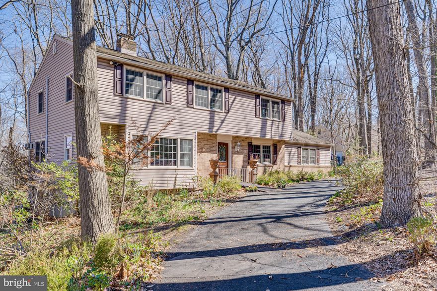 Priced to sell in as-is condition, this home is a rare opportunity for a visionary buyer. With a little imagination and some updates, it could be transformed into your own slice of paradise. Welcome to 3015 Yorkshire Road, a spacious 5-bedroom, 2.5-bathroom home brimming with potential and ready for your personal touch. Nestled on a generous lot and set back from the road, this property offers an ideal canvas to create your dream home. Step inside from the long private driveway and admire the timeless curb appeal of the brick and siding exterior. Inside, the main level is filled with natural light and offers an abundance of space to gather, relax, and entertain. The formal living room features a beautiful brick-surround wood-burning fireplace, crown molding, a detailed chair rail, and oversized windows that bathe the space in light. The formal dining room continues the traditional details, creating a seamless flow into the spacious kitchen—complete with updated appliances, solid wood cabinetry, and plenty of room for culinary creativity. The cozy family room offers a second wood-burning fireplace, hardwood flooring, crown molding, and a convenient half bath—perfect for casual evenings at home.  Also on the main floor is a dedicated laundry room with built-in cabinetry and access to the two-car garage—adding convenience and functionality. Upstairs, you’ll find five generously sized bedrooms and two full bathrooms. The primary suite features wall-to-wall carpeting, a walk-in closet plus an additional closet, and a private ensuite with a stall shower. Three of the remaining bedrooms boast hardwood flooring, while the fifth is carpeted with potential hardwood underneath. A large hall bath with a jetted tub and separate stall shower serves the additional bedrooms. The partially finished walk-out basement spans an impressive 1,000 square feet and includes multiple rooms, offering endless possibilities—whether you envision a second family room, a home gym, an office, or all three, with storage to spare. Outside, the expansive backyard is surrounded by mature trees and greenery, offering privacy and a tranquil setting. Located just minutes from Route 202 and close to all the shopping, dining, coffee shops, and cultural attractions that Doylestown has to offer, this home is a rare find. Don't miss this opportunity—schedule your private tour today!