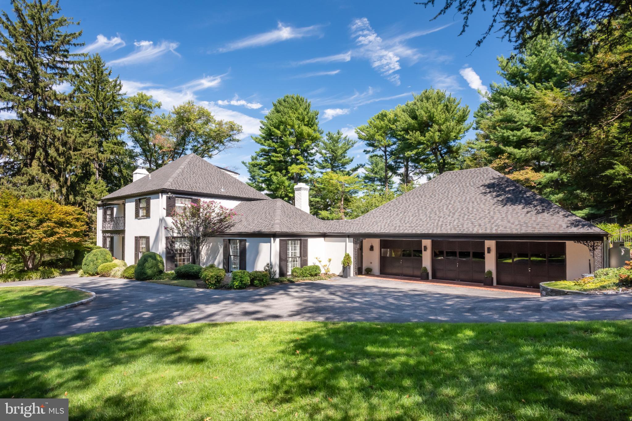 Nestled in a private cul-de-sac, this exquisite French Colonial style residence offers a luxurious lifestyle defined by elegance, privacy, and comfort in desirable Northside Villanova. This home is a true sanctuary, blending timeless architectural charm with modern amenities. A circular drive offers a gracious welcome to a house featuring sun-filled and open interiors boasting spaces for the entire family to gather together or to just find a place to call their own. The open floor plan seamlessly connects the gourmet kitchen, featuring upgraded countertops, stainless steel appliances, and a spacious island, to the family room, where exposed beams, recessed lighting, and a wet bar with built-ins create a warm and inviting atmosphere. Enjoy casual meals in the breakfast area or entertain guests in the adjacent dining room, which opens to a large and sunny living room. A bonus on this level is an adjacent second family room with built-ins. This house can accommodate large-scale entertaining but also provides perfect spaces for quiet evenings at home. Both family rooms are bright and sunny with sliders to the large fieldstone patio and beautiful swimming pool. This private, outdoor oasis features extensive landscaping perfect for outdoor gatherings or quiet evenings under the stars. A new full bath and changing area provide convenience for both guests and family. The home boasts four generously sized bedrooms, each designed with comfort in mind. The primary suite is a true retreat, featuring his and hers en-suite bathrooms, a separate dressing room, and a Juliet balcony with views of the picturesque outdoor area. The third floor features a convenient office and plenty of storage. Venture to the lower level, where a finished, heated basement awaits, offering ample space for recreation or relaxation. This house has been meticulously maintained by the current owners, with a new roof installed in 2024, as just one example. Additional highlights include a three-car attached garage with ample storage and EV charger, geothermal energy, a generator, a new mudroom with a dedicated dog bath and energy-efficient double-pane windows that enhance the home's comfort and sustainability. Security features, including a comprehensive system and smoke detectors, provide peace of mind. This exceptional property is not just a home; it's a lifestyle. Experience the perfect blend of luxury, comfort, and tranquility in this stunning residence, where every detail has been thoughtfully curated to create a warm and inviting atmosphere. Conveniently located near major transportation, prime dining and shopping, and in award winning Lower Merion School District.