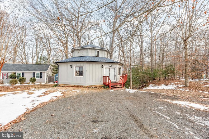 Welcome to this delightful 1862 SQFT 3-bedroom, 2-bath home nestled in the heart of Lusby! Set on a serene .35-acre lot, this home offers a private wooded retreat for you and your loved ones. Step inside to discover new flooring in the inviting living room, where large sliders open to a spacious deck, seamlessly blending indoor and outdoor living. The kitchen boasts freshly painted grey cabinets, adding a modern touch to its charm. Two cozy bedrooms and a full bath are conveniently located on the main level, while the upstairs features a large primary suite, perfect for added privacy or a quiet retreat. With its character-filled design and spacious layout, this home is as unique as it is welcoming. Don't overlook the large crawl space, offering additional storage or potential opportunities to suit your needs. Come experience this hidden gem for yourself!