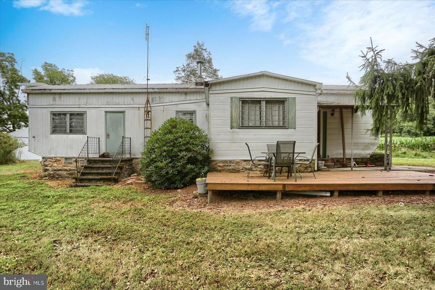 Nestled on a generous 2.14-acre lot, this charming mobile home offers a unique blend of comfort and tranquility. Built in 1961, the single-wide design features aluminum siding, ensuring durability while maintaining a cozy aesthetic. With one spacious bedroom and a full bathroom, this home is perfect for those seeking simplicity and ease of living. Step outside to discover the inviting exterior, complete with outbuildings that provide ample storage options, including a detached garage and a wood/metal shed. The expansive front yard and open spaces invite you to enjoy the beauty of nature, while the road frontage offers convenient access. The property is ideally situated near a serene stream, providing a picturesque view and a peaceful ambiance. Imagine relaxing by the water, listening to the gentle sounds of the stream, or enjoying outdoor activities in this rural setting. With water access, you can easily indulge in leisurely days by the water. Parking is a breeze with a detached garage and additional driveway spaces, ensuring you have room for all your vehicles and toys. This property is not just a home; it's a lifestyle, offering the perfect retreat from the hustle and bustle of everyday life. Embrace the opportunity to create lasting memories in this delightful space, where comfort meets nature.