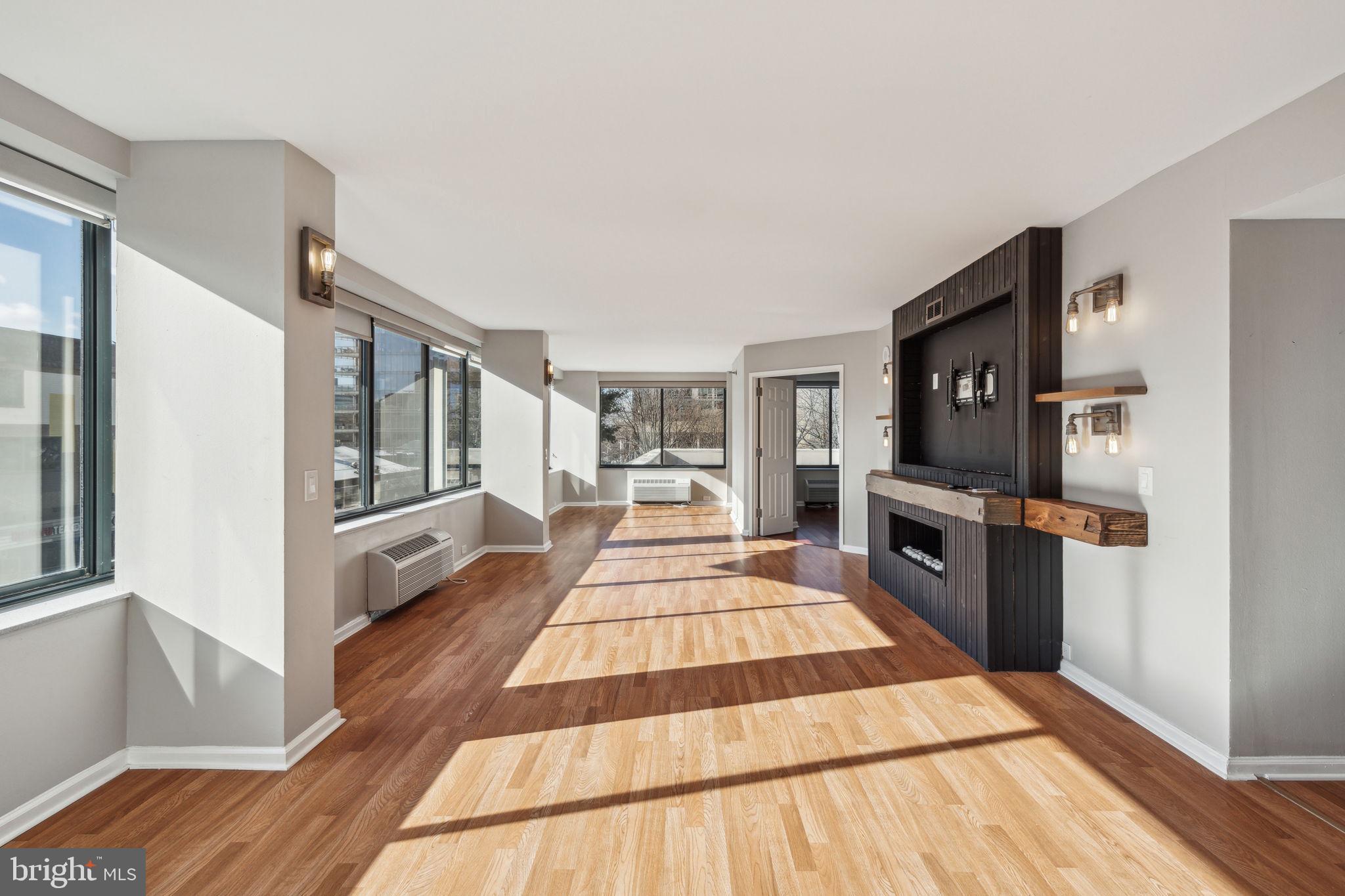 ***DEEDED PARKING SPACE INCLUDED*** Welcome to 2001 Hamilton Street #302, a beautiful home in the heart of the Art Museum Area! This home boasts 2 bedrooms, 2 bathrooms and 1,440 square feet of living space. As you step inside, you'll immediately notice the pristine hardwood flooring and expansive windows equipped with automatic shades, offering abundant natural light throughout the day. The living area also has wall/ceiling light fixtures, entertainment console built with invisible wiring for TV, and an electric water vapor fireplace perfect for entertaining guests. The kitchen features stainless steel appliances, quartz countertops, gray stone backsplash, tons of white cabinetry for storage, and a breakfast bar perfect for barstool seating. The sink and faucet were newly replaced and added a full height pantry cabinet and beverage cooler. Then make your way to the office space area that features a wet bar with quartz countertops, painted cabinets, new undermount sink with faucet and glass washer, wine refrigerator, and InSinkerator water filtration with instant hot water added. The 1st spacious bedroom offers a custom pax wardrobe system and has an en-suite bathroom that includes a new stacked washer/dryer and features new flooring, quartz countertops, pivot mirrors, vanity backsplash, vanity lighting, double vanity sinks, double storage vanity with undermount sinks, custom faucets, and tiled walk-in rain shower. The 2nd spacious bedroom also has its own bathroom that features new floor tiles, quartz countertops, painted vanity cabinets, new counter mount sink with waterfall faucet, new mirror and light fixtures, and new dual flush toilet. This home is complete with a secured parking space! Enjoy a fresh welcome from the building front with newer awnings, facade, and lobby. Condo amenities include 24-hour fitness center, outdoor green space, outdoor heated pool with terrace, building concierge, 24-hour building security, lending library, onsite management, meeting space and more. Located in a prime area, enjoy easy access to dining, shopping, public transportation and historic areas. Schedule your showing today!