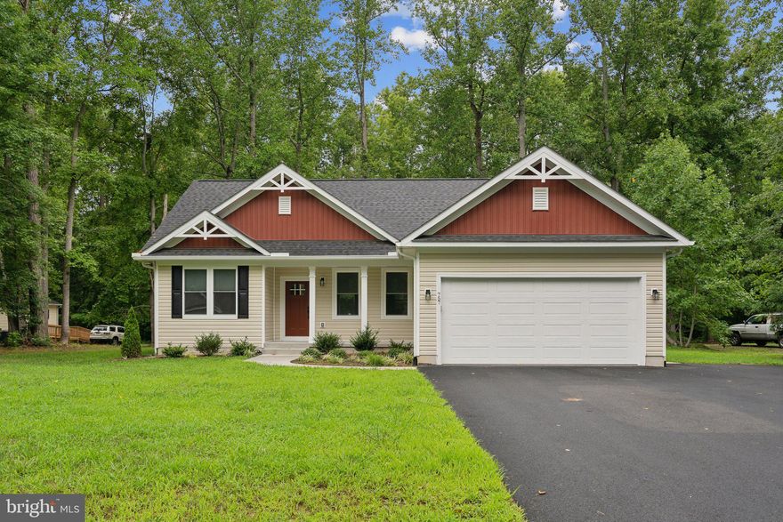 Stunning custom home with 2 car garage is loaded with upgrades on premium lot backing to wooded common area and 4 houses from Crystal Lane Beach. Incredible kitchen features white cabinetry with under cabinet lighting, huge center island with quartz countertops, stainless appliances and subway tile backsplash*Upgraded LVP flooring and custom paint throughout*Large family room with recessed lights and ceiling fan with remote*Master suite offers a tray ceiling with ceiling fan with remote, large walk-in closet and luxury master bath with quartz countertops and large format ceramic tile*Large secondary bedrooms each with ceiling fan and remote as well as 2nd full bath with large format ceramic tile*Enter from the garage to a back hall with custom shelving/cubbies*Large laundry room upgraded with laundry tub*Paved driveway with extended pad for extra parking for boat*Main electrical panel is upgraded and pre-wired for generator hook-up*Top down/bottom up honeycomb rooms with darkening blinds throughout and so much more*Conditioned crawl space*Nice composite deck overlooks level backyard backing to common area*Exterior motion sensor lighting on all 4 corners of home*Cabin Point is a water access community with great amenities including private beaches, boat ramps, community pool, tennis courts, clubhouse, tot lot and boat/RV parking! Home is also listed for sale!