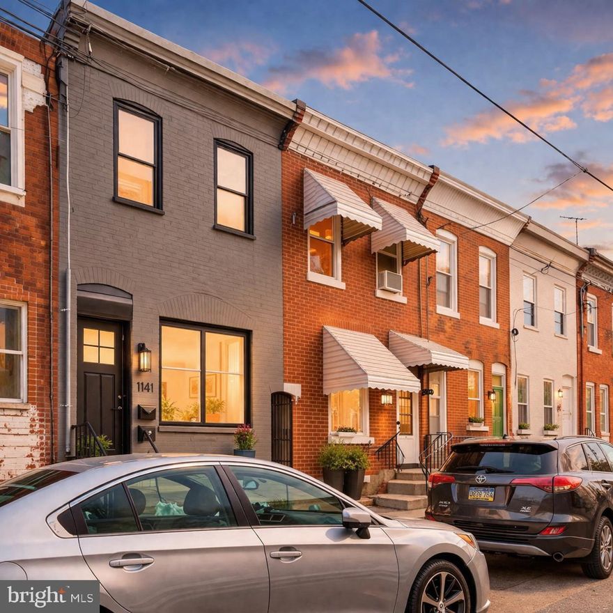 Artfully rebuilt from the inside out with all-new plumbing, electric, HVAC, roof, windows, plus a 10-year tax abatement and premium location just a block and a half from vibrant Passyunk Avenue. The rare combination of peace of mind, low ownership cost, and stone’s throw access to South Philly’s most dynamic corridor you’ve been dreaming of! Top-quality renovation including best-of-class materials and dual primary suites each with private ensuite baths. Dramatic curb appeal with slate-gray brick exterior, black-trimmed windows, solid marble steps, bold black entry door. Wide-open main-floor layout with wide-plank white oak floors, striking exposed brick accent wall, sculptural steel-and-wood staircase with solid wood treads, sleek black steel balustrades, wood railings. Convenient main-floor powder room, thoughtfully designed eat-in kitchen with custom two-toned cabinetry, brushed gold hardware, undercabinet lighting, modern vertical tile backsplash, sleek quartz surfaces, undermount sink, industrial-style pull-down faucet, stainless GE appliance package including French-door refrigerator with in-door beverage dispenser, excellent cabinet and counter space. Step out to private courtyard. Rear bedroom with flush-mount LED fandelier, private sumptuous bath featuring tub/shower combination, earthy hand-glazed tile, frameless glass barndoor enclosure with chic matte-black hardware, geometric tile flooring, furniture-style vanity with drawers. Bright front bedroom with modern enclosed fandelier, double closets, luxurious Jack-and-Jill bath with cabinet-style vanity and frameless glass shower with rainfall shower head and floor-to-ceiling porcelain tile. Partially finished basement with painted joists, inset LED lighting, crisp parged walls, painted floor. Conceptual rendering showing potential finished basement layout; seller open to discussing completion or credit depending on offer terms. All-new permitted mechanicals. throughout Walk to beloved Passyunk Avenue with its over 50 shops, boutiques and numerous James Beard-recognized restaurants; outdoor enthusiasts will fall in love with Columbus Square Park, featuring 3.6 acres of green space with two dog runs, a rose garden, nature walk, and water-fountain play area. 10-year tax abatement pending. Location, quality, design — it doesn’t get any better! Shows beautifully!