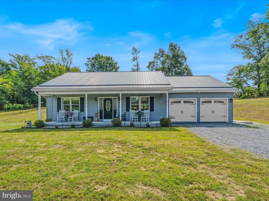 Maintenance-Free Rancher! This 2100 square foot residence boasts a spacious open kitchen equipped with granite countertop, center island and stainless steel appliances, a dining room with glass doors that lead out to an expansive patio ideal for large family gatherings, and a living room. The property also features three bedrooms, including a generously sized primary bedroom with an attached bath, complete with a soaking tub and large two-person shower. Additional features include a full hall bath, luxury vinyl plank flooring throughout, an unfinished basement, 2 car garage, covered front porch, public water, public sewer and a heat pump. The property is situated on a .994-acre lot, accessible via a paved road, and offers a beautiful setting for this stunning home.