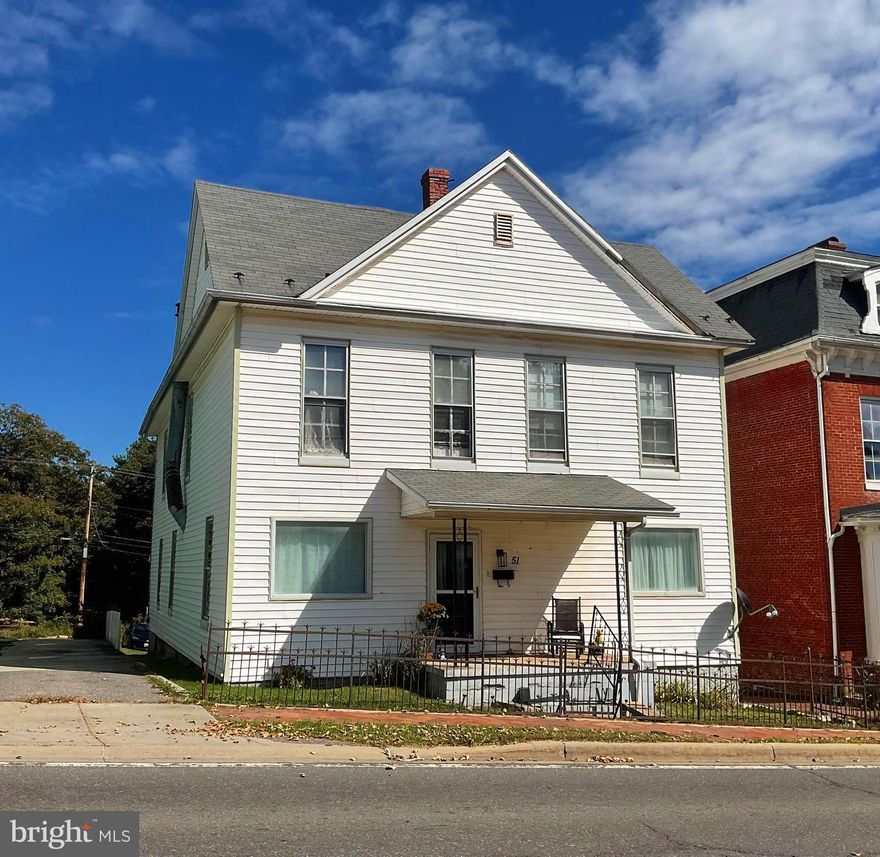 Who wouldn't want to watch a parade or the classic cars of Cruisin' Main Street from the front porch of this charming 5-bedroom home, 2 bath home in Frostburg's Historic District?  Bursting with character and timeless charm, this home offers beautiful detail and plenty of space for comfortable living.    The main level features a dining room with on of Frostburg's original gas fireplaces, a large office (or optional main level bedroom) with built in bookshelves, a cozy living room with Venetian Plaster walls and a brick fireplace, a well sized kitchen, and a convenient laundry/pantry area along with a full bathroom.  Upstairs you will find five bedrooms and a full bathroom.  Two staircases provide easy access between levels adding to the home's historic appeal.  The rear of the home offers a two-story deck, large yard and off-street parking for 3 vehicles.
Additional highlights are the original hardwood floors beneath the carpeting and a pull-down attic offering ample storage This home has been lovingly maintained and is ready for it's next chapter - just waiting for your personal touch.