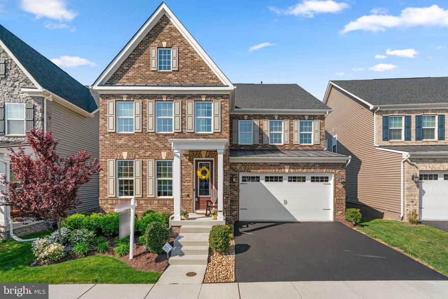 Thoughtfully upgraded and beautifully appointed, this refined Colonial blends modern design with functional living and exceptional outdoor spaces, all set against picturesque sunset views in sought-after Heritage at Two Rivers. // Offering 3,680 finished square feet, the home showcases an open-concept layout filled with natural light, enhanced by elegant architectural details such as coffered ceilings, energy-efficient LED recessed lighting throughout, and stylish, cohesive window treatments. Luxury vinyl plank flooring flows seamlessly across the main level, beginning in the welcoming foyer where French doors open to a private study—an ideal work-from-home retreat. A spacious formal dining room and a well-placed powder room add both sophistication and convenience. At the heart of the home, the expansive great room impresses with a coffered ceiling and a striking stacked-stone electric fireplace, creating a warm yet modern focal point. The space opens effortlessly into the gourmet eat-in kitchen, designed for both entertaining and everyday living, featuring a large quartz island with bar seating, crisp white cabinetry, stainless steel appliances, a chic subway tile backsplash, quartz countertops, and a sunlit breakfast area. A generous walk-in pantry and a custom-designed mudroom provide exceptional storage and organization. // Upstairs, a versatile loft-style sitting area leads to four spacious bedrooms, three full bathrooms, and a convenient laundry room. The luxurious primary suite offers a serene retreat with a tray ceiling, dual walk-in closets, and a spa-inspired bath complete with a soaking tub, frameless glass shower, and separate vanities. Secondary bedrooms are well-proportioned, each with walk-in closets, and a shared dual-entry bath. // The fully finished walk-out lower level is an entertainer’s dream, featuring expansive recreation space and a custom wet bar with a built-in refrigerator, dishwasher, and abundant cabinetry, along with a full bathroom for added convenience. // Outdoor living is equally impressive, highlighted by an elevated, low-maintenance composite deck with a privacy wall and retractable awning, leading down to a fully fenced backyard. The setting offers breathtaking pond and tree-lined views, creating a peaceful backdrop for gatherings or quiet evenings at sunset. // Residents of Heritage at Two Rivers enjoy access to resort-style amenities, including a community pool, completing this exceptional offering.