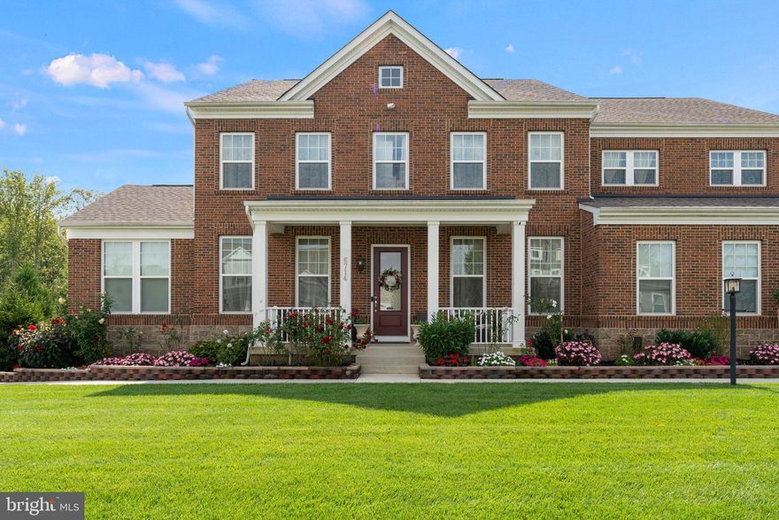 Welcome to 6714 Dogwood Bloom Court—an impressive brick-front home with a 2-car garage, ideally located on a generous corner lot in the sought-after Potomac Reserve community. Situated on nearly half an acre, this expansive residence features 7 bedrooms and multiple living areas spread across three fully finished levels, offering an ideal setup for multi-generational living, effortless entertaining, and everyday comfort.
The main level showcases LVP flooring throughout, an elegant formal dining room, a private office with custom built-ins, and a spacious in-law or multi-generational suite with a full bath. The heart of the home is the gourmet kitchen, featuring white quartz countertops, a large island, gas cooktop, double wall ovens, stainless steel appliances, coffee bar area, and an abundance of storage space. The kitchen opens to a bright living room with a cozy gas fireplace and a morning room filled with natural light, offering walkout access to the spacious Trex deck. A convenient powder room completes this level.

Upstairs, the elegant primary suite offers a peaceful retreat with a cozy sitting area, two spacious walk-in closets, and a luxurious en-suite bathroom featuring dual vanities, a soaking tub, and a large walk-in shower. Bedroom 2 boasts its own private full bath and walk-in closet, while Bedrooms 3 and 4 are equally well-appointed with generous walk-in closets. A shared hallway bathroom with double vanities and a tub/shower combo, along with a convenient laundry room complete with a sink, enhance the upper level’s comfort and functionality.

The fully finished walk-out lower level offers versatile living and entertaining space, featuring a spacious recreation room, a full bathroom with a walk-in shower, and Bedrooms 6 and 7. Fitness enthusiasts will appreciate the dedicated gym complete with mats and wall mirrors. The custom bar area is ideal for hosting, complete with granite countertops, an ice maker, refrigerator, sink, and kegerator. Additional highlights include under-stairs storage and plenty of extra room to suit your lifestyle needs.

Step outside into your private backyard oasis, designed for both relaxation and entertaining. Enjoy the in-ground pool, perfect for cooling off on hot summer days, surrounded by an expansive stamped concrete patio ideal for lounging or hosting gatherings. A dedicated storage shed provides space for all your outdoor tools and pool accessories. The covered stone outdoor bar is an entertainer’s dream, featuring a built-in gas grill, slate countertops, and a large island with ample bar seating—making it the perfect spot for cookouts and celebrations. As the evening winds down, gather around the built-in stone fire pit. The fully fenced yard offers privacy and security, while lush landscaping and a front-and-back sprinkler system complete this exceptional outdoor space.