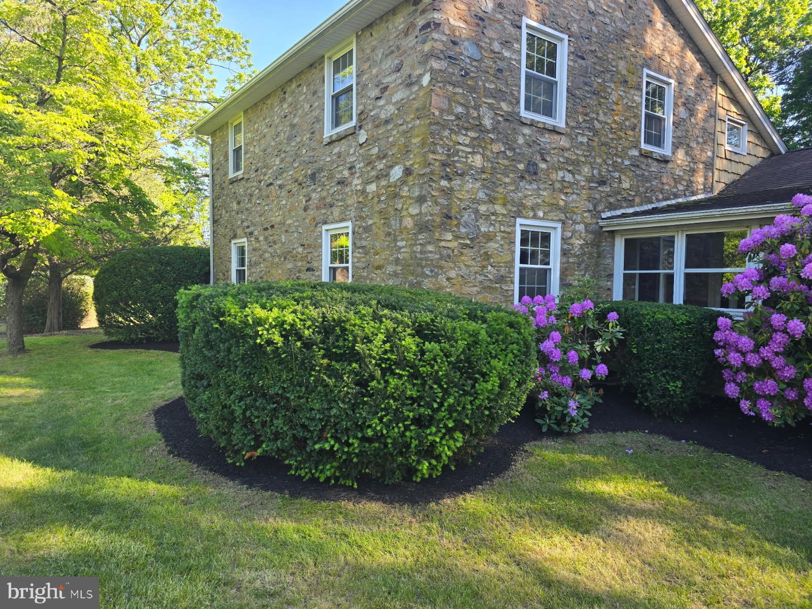 Nestled on 11 picturesque acres, this charming Stone and Cedar farmhouse offers the perfect blend of rustic beauty and modern convenience. Featuring gorgeous hardwood floors throughout, the home boasts 3 spacious bedrooms, including a convenient first-floor suite, and 3 full baths, ensuring ample space for family and guests. The heart of the home is the expansive kitchen and dining area, views of exposed stone and pane glass walls, ideal for family gatherings and entertaining. An environment to spend hours just enjoying the architecture design. Step outside to a stunning flagstone patio, perfect for relaxing or enjoying the serene surroundings. Need additional space? The garage has been thoughtfully converted into a versatile studio, office or family room. The property also includes several buildings for vehicle storage, contractors workspace or raising animals and there's a detached building with an office area, and interior storage offering endless possibilities for work, hobbies, or expansion. All outbuildings are accessible by private road. Whether you're looking to embrace a peaceful country lifestyle or create a personalized retreat, this farmhouse has it all. Make it yours today and experience the perfect balance of comfort and charm!