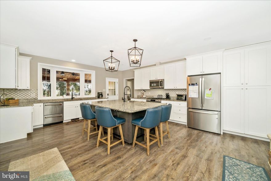 Updated 5BR/5.5BA estate on 6.7 acres. Renovated 2020 + many upgrades. Gourmet kitchen with Café appliances, LG stove, large island, and bay‑window views. Main‑level primary suite with fireplace and walk‑in closet. Upper level includes 3 BRs with a 2nd primary suite. Finished 2023 basement with rec room, BR, and full bath. Fully fenced with solar gate, cedar‑wrapped porch, hot tub, SISU sauna, outdoor TV/speakers, and fire pit. Includes 3‑bay pole barn, rustic barn, chicken coop, EV charger, wired internet, and whole‑house generator.