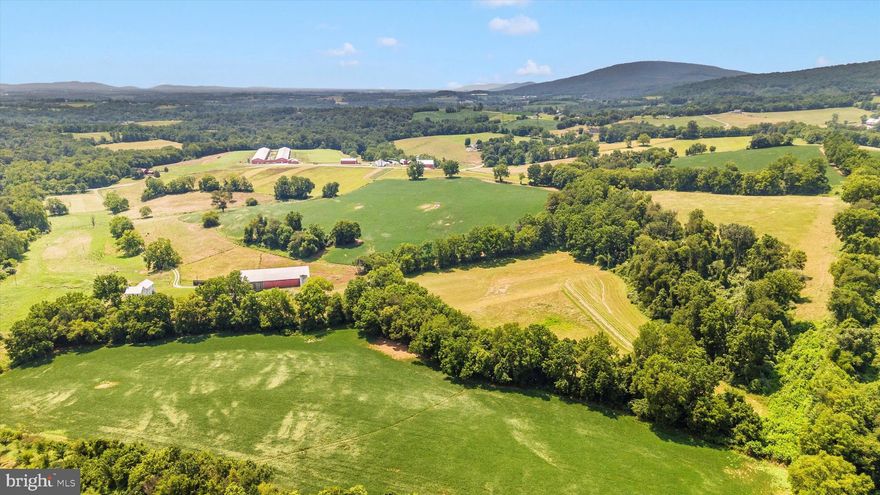 PRICE IMPROVEMENT -  Rare opportunity to purchase a farm in the Middletown Valley.   This property is improved with a historic mid 1800's  german "L" style residence which features almost 3,000 SF above grade living area, 9' ceilings on both levels, large rooms, four fireplaces, a main ornate staircase and a second functional staircase, a two level 33' long porch/balcony, and some original trim and hardware, .  The front section of the home  is 'move-in ready' and includes a large kitchen/breakfast room, living room, 2 bedrooms, full bathroom; the back section (two large rooms on each level) and the porch/balcony are ready for finishing touches.  Recent updates include new metal roof with snow guards and new gutters (2022), new windows (2023), new Regal Star furnace (2023), new electric panel (2022) and mostly new wiring.   The cellar is accessible both from the interior and the exterior.     If a historic renovation is not your desire - the house can be razed, and a new home built in a different location. 

Farm features include a circa 1851 seven bay 130' x 48' bank barn served with water and electric. The lower level has wooden cattle stalls  and a 16' wide x 11' tall 'drive-through' machine shed.  The stone foundation, beams and posts are in excellent condition.  New metal roof and guttering installed in 2013.  Additional agricultural buildings include two chicken coops with fenced runs and water spigots; a run-in shed; and a pig barn

The soils are excellent:  26% of the property is classified as prime farmland and 50% of the property is classified as farmland of statewide importance.   The property includes approximately 72 acres of tillable land, 14 acres of fenced pasture and 31 acres of forest.   There is a spring fed waterer in the pasture which must remain in place until 2030.  In 2024, fifty acres were planted in row crops and 21 acres were used to grow hay.  The topography ranges from gently rolling to rolling; slopes are primarily between 5% and 15%.   

Water features include two 'year round' streams two intermittent streams and several springs.   Grindstone Run (width ranges from 12' to 20') traverses the property for 1,500 linear feet; a small but flowing tributary of Grindstone Run also crosses the property for 1,500 LF.  

No subdivision rights remain (MALPF easement) but tenant houses are possible.   The property is subject to a 150' wide easement with Potomac Edison for above ground electric lines and a 60' wide easement with Dominion Energy for a buried natural gas line and a sewer line easement with the town of Myersville.

Note:   The SDAT record lists the wrong acreage.  The Property is 130.055 acres per boundary survey performed in 2020.