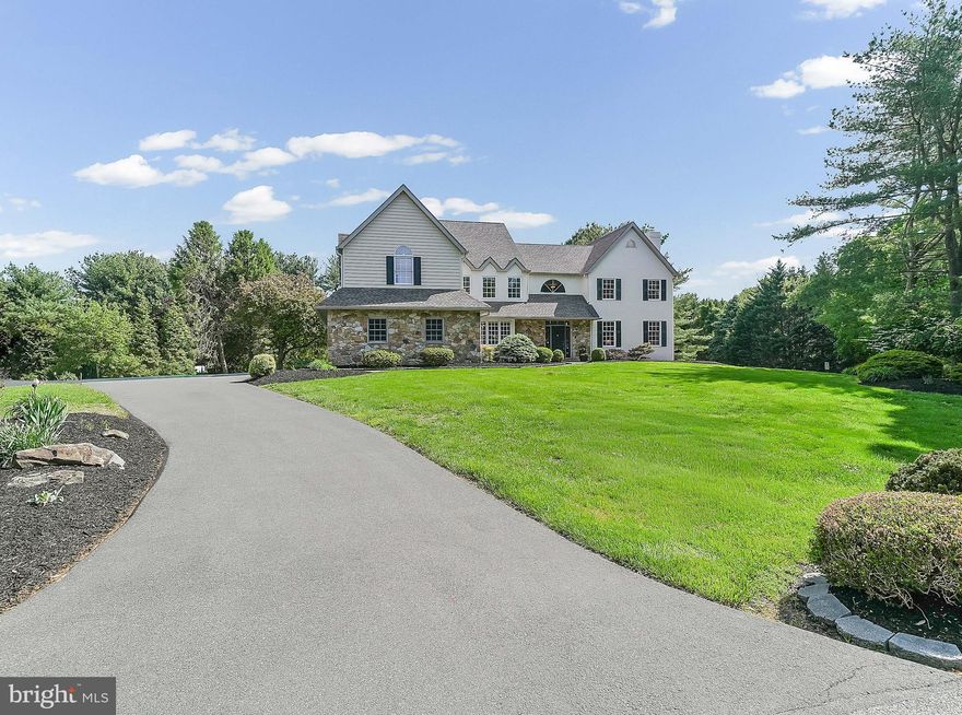This property is situated in a small enclave of custom built, executive homes, located in one of
the top ranked school districts in the nation, Unionville Chadds Ford, and it is practically walkable
to the Middle School and High School Campus This meticulously maintained, stately colonial style home is close to Longwood Gardens, Kennett Square Golf Club, Downtown Kennett Square, Historic Chadds Ford, Greenville, Wilmington and Philadelphia. The Philadelphia and Baltimore Airports are both easily accessible. Numerous restaurants and retail stores including Whole Foods, Wegmans, The Fresh Market, and Trader Joe's, are just a short drive away. This area boasts nature parks, hiking trails, golf courses, pickle ball and tennis courts, horseback riding, birding and so much more. Within the community, this home is sits on a generously sized corner lot with a level acre of land and a lovely sense of privacy. As you approach, you will appreciate the curb appeal of this elegant residence. The lovely flagstone sidewalk, front patio, and generously sized porch make a welcoming first impression. Once inside the two-story entry, rich hardwood flooring and sweeping staircase provide a grand welcome. To the right of the entry is the formal living room, anchored by a stately natural gas fireplace amply sized to entertain large groups. To the left is the elegant formal dining room which easily fits a table for twelve and a lovely, light-filled deep window wall. Adjacent to the dining room is a stunning chef’s kitchen, featuring a wonderful, oversized, center island. The kitchen has been completely updated with glass front cabinetry, stunning granite countertops, a wonderful travertine and glass tile backsplash, and upgraded fixtures. The kitchen also has a generously sized breakfast table area with patio doors leading to the expansive deck which overlooks the lovely backyard and provides an amazing entertaining flow for gatherings and events. Next to the kitchen a doorway leads to one of TWO main level half baths and a laundry room which provides direct access to the 3 CAR GARAGE with an epoxy finished floor and side entry to the home. The family room is OPEN to the kitchen and boasts cathedral ceilings with sky lights, a large stone, gas burning fireplace, and beautiful windows overlooking the stunning backyard. There is a second half bath just beyond and a lovely office or library room adjacent complete with a wall of built in cabinetry. The desk area provides an expansive view of the outdoors. The upper level of the home features a spacious primary suite with a stunningly renovated bathroom that boasts two vanities, a separate room with a custom walk-in shower, and a stylish soaking tub centered in three walls of windows overlooking the gorgeous property; the perfect place to unwind after a long day.  Four additional large bedrooms and two additional full bathrooms complete the upstairs space; the fifth bedroom is large enough that it can be used as an upstairs playroom or den. However, the finished, walk-out basement is really the icing on the cake for entertainment and making memories. This space has a full gym, a well-equipped hobby/work room, a generously sized great room, a wet bar, and a large additional recreation space plus a THIRD half bath. There is also a separate, sunny room in the basement which is perfect for plants or to use as an artist’s studio or yoga space. Custom built with timeless design and quality craftsmanship, this home is fresh
with new paint, new carpet, an upgraded kitchen and primary bath making this a wonderful, move in ready special property for the next lucky owners to call home.