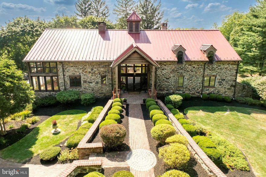 Rarely do you see a one of a kind completely updated Converted Barn in the heart of Chester County, only a few miles from the center of West Chester Borough become available for a new owner.   Originally built in 1840, this home boasts over 7,000 total Sq ft of living space, with a unique interior that was meticulously renovated to the highest standards in quality, yet preserved the intimate craftsmanship of days gone by. The highlights of this home are many and include a brand new Bluebell Fine Cabinetry and Design custom kitchen with a Wolf stove, Sub-Zero refrigerator with cabinet panels, both butcher block and quartz island, quartz countertops and custom built-in. The great room features a two story stone and brick fireplace, floor to ceiling Marvin Windows and a vaulted tongue-and-groove ceiling. The main floor also features a slate foyer, slate powder room, slate laundry and a vaulted tongue-and-groove ceiling dining room, also with floor to ceiling windows and french doors. The main living floor contains a separate den with a built-in and the primary bedroom.  The primary suite bedroom features vaulted ceilings, a walk-in closet with a custom California Closet and an attached primary bath featuring marble floors, a walk-in shower, granite vanity and Jacuzzi tub.  The main section of the second floor features a loft area great for a home office or sitting area, along with two guest bedrooms with 16 plus foot ceilings and a hallway full bath.  There is a second floor primary suite with ensuite bath containing ceramic tile and a walk-in shower, a large walk-in closet with California Closet built-ins and a sitting area. The full walkout lower level of the home features an additional approximate 2400 sq ft of living space with a wet bar and refrigerator, stone fire place, TV/media room, powder room, a large flex room, a workshop, arched doorways, chair rail, wainscoting and a door leading to an unfinished bonus room waiting for the next owner to put their touches on.  On this level is the three-car side attached garage with new epoxy flooring. The exterior of the home features breathtaking stone work, a standing seam metal roof installed in 2015, an Azek Deck installed in 2022 with built-in lighting, a detached studio which is perfect for storage or waiting for renovation.  The long driveway features a privacy gate.  This extravagant property is uniquely breathtaking and a must see! The grounds on this special property are also one of a kind.  There is separate “studio” building with wood cathedral ceilings, a wall of windows and stone structure that is beautiful on the outside with a newer metal roof and the interior space holds endless possibilities to make this building a special place for a studio, future Pool house or an indoor / outdoor recreational building.  There are brick walking paths and patio’s around this spectacular building that enhances your ownership experience.  Within the Award Winning West Chester School District and the location of this property just off Route 52 and S. Creek Rd makes for a perfect commute to West Chester, Wilmington, DE,  Philadelphia and King of Prussia.   

YOUTUBE LINK TO A PROPERTY VIDEO https://youtu.be/O1GhqngVIrI