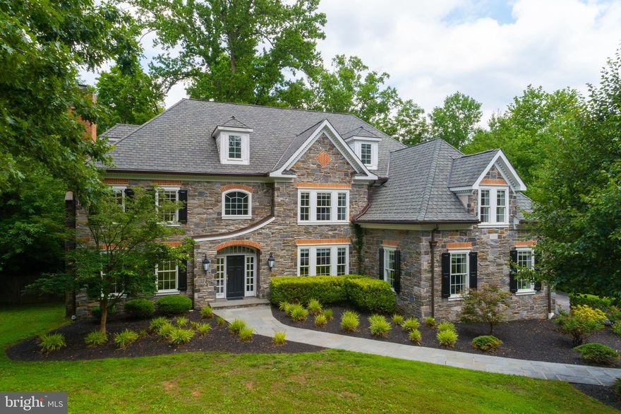 This gorgeous, 5 bedroom, 5.2 bathroom, stone colonial is situated on nearly an acre of beautifully landscaped grounds and offers optimal privacy and serenity. Enter through a secure, gated entry and follow the private driveway shared with just one other grand home. This exquisite home is set far back from the road and is surrounded by lush greenery and fully fenced in grounds. A beautiful flagstone walkway will lead you to the inviting main entrance which opens up into an impressive 2-story foyer featuring a sweeping Juliette staircase, stunning architectural details, beautiful moldings, and rich hardwood flooring. This home's desirable open floor plan offers large rooms, high ceilings and ample natural light. The first floor houses a formal living room, formal dining room, family room, library, kitchen with breakfast room, two powder rooms and a mudroom, all which flow nicely into the entryway of the home. The large dining room with convenient access to a butler pantry features elegant chair rail detail and a beautifully designed triple window providing gorgeous views of the lush grounds. The spacious formal living room with gas fireplace leads to a formal powder room and elegant library with expansive built-in bookshelves and cabinetry. Adjacent is a large family room with vaulted ceilings, skylights, gas operated fireplace, custom built-ins, and french doors which provide access to a spacious deck and large, flat backyard. Off of the family room is an open-concept kitchen and breakfast room which offers both beauty and functionality. The gourmet chef's kitchen features granite countertops, tumbled stone backsplash, a large center island, 42" high cabinets, gorgeous custom-built armoires with Mackenzie Childs hardware, Miele coffee bar, Bosch Dishwasher, Viking oven and 6 burner gas range with grill and griddle, Viking hood and Viking refrigerator and GE microwave. The kitchen opens up to the butlers pantry and dining room making the first floor ideal for entertaining. The breakfast room houses a gorgeous custom-built kitchen table and provides access to the rear deck with awning through beautiful French doors. To complete the main level you will find a mudroom which features matching custom-built pantry cabinets, a second powder room, large walk-in closet and direct access to the three car garage.  The home is fit out with a central vac system and the HVAC systems were recently updated. The second floor offers 5 bedrooms, 4 full bathrooms, and a conveniently placed laundry room. Double doors open to the large master suite with a sitting room featuring his and hers walk-in closets and en-suite bathroom equipped with a Whirlpool tub, floor to ceiling glass shower and double sink vanity. Each additional bedroom offers generous closet space and tall windows. From the hallway, follow the stairs to the finished third level offering a large bonus space with ample storage and a full bathroom. The partly-finished basement spans the entire footprint of the home and offers high ceilings making this the ideal space for a home gym, game room, and/or playroom - the options are endless!  Perfectly located with easy access to the Villanova train station and major highways, in a top school district, and close to many shops and restaurants. There is so much more to see and feel in this beautiful Main Line estate. Schedule your tour today and prepare to fall in love! Check out the 3D Matterport Tour - https://my.matterport.com/show/?m=KD8zQyJb5rr&mls=1