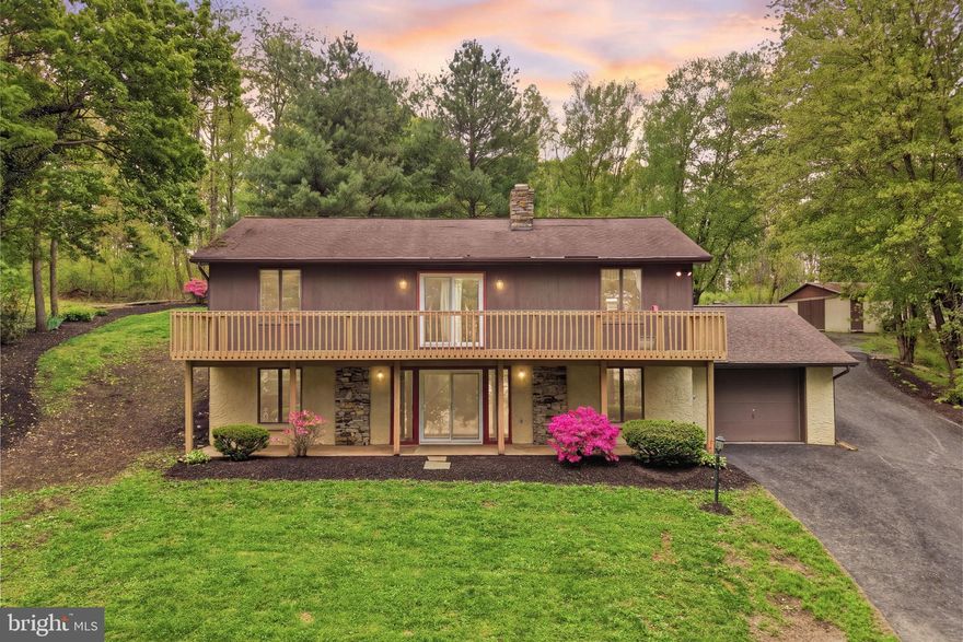 If you’ve been craving more space, more privacy, and a setting that actually feels like a reset at the end of the day, this one is worth a look! Set back on nearly 10 wooded acres in East Fallowfield, this property offers that tucked-away, peaceful setting while still being close to everyday conveniences.
Inside, the main living space immediately stands out with vaulted ceilings, exposed beams, and a floor-to-ceiling stone fireplace that anchors the entire home. It’s one of those spaces that just feels warm the second you walk in. Natural light pours in, and the layout flows easily from the living area into the kitchen and dining space. The kitchen offers plenty of cabinet space, a breakfast bar for casual mornings, and an easy flow for hosting or just keeping things simple day to day. The living room brings in great natural light and overlooks the front yard. You’ll also find a spacious primary bedroom and full bath on the main level.
Downstairs, the walkout lower level adds a ton of flexibility, with a large family room, complete with a wood-burning stove, additional bedrooms, a full bath, a dedicated office or study, and laundry. Whether you need extra space for guests, working from home, or just spreading out a bit more, it’s all here.
Outside is where this property really stands out. Open yard space, wooded surroundings, and the kind of privacy that’s hard to find. Plus a barn/pole building  that gives you options for storage, hobbies, or projects.
If you’ve been looking for a property that offers space, character, and a setting that feels like your own little retreat, this is one you don’t want to miss.  Schedule your showing today!