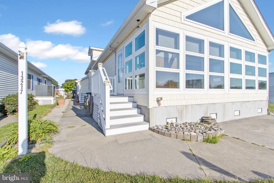 Just listed in the highly coveted neighborhood of Montego Bay, this RARELY available 4 bedroom, 3 full bathroom home has everything you need to make your summer beach house dreams come true! Upon entry you will find yourself in the gorgeous 3-season room, surrounded by sunlight with floor to ceiling windows. Enjoy evening cocktails, morning coffee or host a crab feast for you and your friends/family in this welcoming retreat! Through the slider, you immediately enter into the stunning, completely open concept living, dining and kitchen area. With vaulted ceilings, tons of natural light and gleaming hardwoods throughout, this area offers plenty of space for entertaining and relaxation alike. The kitchen offers custom cabinetry and a MASSIVE island with room for 6+ barstools!  The living room is oversized, perfect for a large, sprawling sectional, while the dining space has room for a large table and chairs! There is also a large pantry. Down the hall, the hardwoods continue, leading you first to the laundry room and then to the first floor bedrooms and bathrooms. The first two bedrooms are generously sized with ample closet space and a shared full bathroom! On this main level you will also find the first of two large primary suites that this property offers - complete with plenty of closet space and a full bathroom with double vanity, tub and shower. As you proceed to the upper level, you will find an incredible open concept staircase, overlooking the rest of the living space. Upstairs there is a large, insulated storage room, double closet nook and tons of additional storage behind the eves! But the absolute BEST part of the upper level is yet another large primary suite with another en suite bathroom. This second primary also offers vaulted ceilings with gorgeous, coastal feeling tongue and groove detail as well as tons of natural light through the dormers and window! No detail was overlooked in this property and it truly shows. The exterior has a lush front yard, double parking pad, room for gardens on the side of the house and an attached storage shed for all of your beach essentials! The home has dual zone HVAC (first floor gas furnace/AC - 2022 and upper level heat pump unit/AC - 2017 when second floor addition was added). Montego Bay has an annual HOA fee of only $396 which allows all residents to enjoy 2 large community pools, tennis courts, pickleball & shuffleboard courts, a 9-hole mini golf course, walking paths around a large pond, bayfront views, piers for crabbing and fishing, just a short walk to Northside Park (watch the amazing fireworks on the 4th of July here!) and just a short walk to the beach, as well as local restaurants and shops! Run - Don't Walk! This one will be gone before you know it!