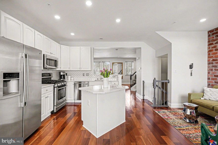 OPEN HOUSE SUNDAY APRIL 26TH 10AM-12PM. Welcome home to this beautifully updated and move-in ready townhome offering the perfect combination of style, space, and functionality!

Step inside to find rich hardwood flooring and a bright, open layout filled with natural light. The main level features a stunning eat-in kitchen with white cabinetry, quartz countertops, stainless steel appliances, subway tile backsplash, and a large center island, perfect for cooking and entertaining. Just off the kitchen, enjoy a spacious dining area with access to a private rear deck, ideal for relaxing or hosting guests.

The home offers multiple living spaces, including a welcoming living room with a striking exposed brick accent wall and a cozy lower-level family/recreation room—perfect for movie nights or additional entertaining space.

Upstairs, the primary suite is a true retreat, featuring a spacious layout, hardwood flooring, and a beautifully updated en-suite bath with a soaking tub, separate glass shower, and dual vanity. Additional bedrooms are generously sized with ample closet space and share an updated full bathroom.

The finished lower level provides even more versatility with a half bath, additional living space, and walk-out access, making it ideal for guests, a home office, or flex space.

Enjoy outdoor living on the elevated deck overlooking the neighborhood, offering a great space to unwind.

With modern finishes, thoughtful updates, and a flexible layout, this home checks all the boxes!