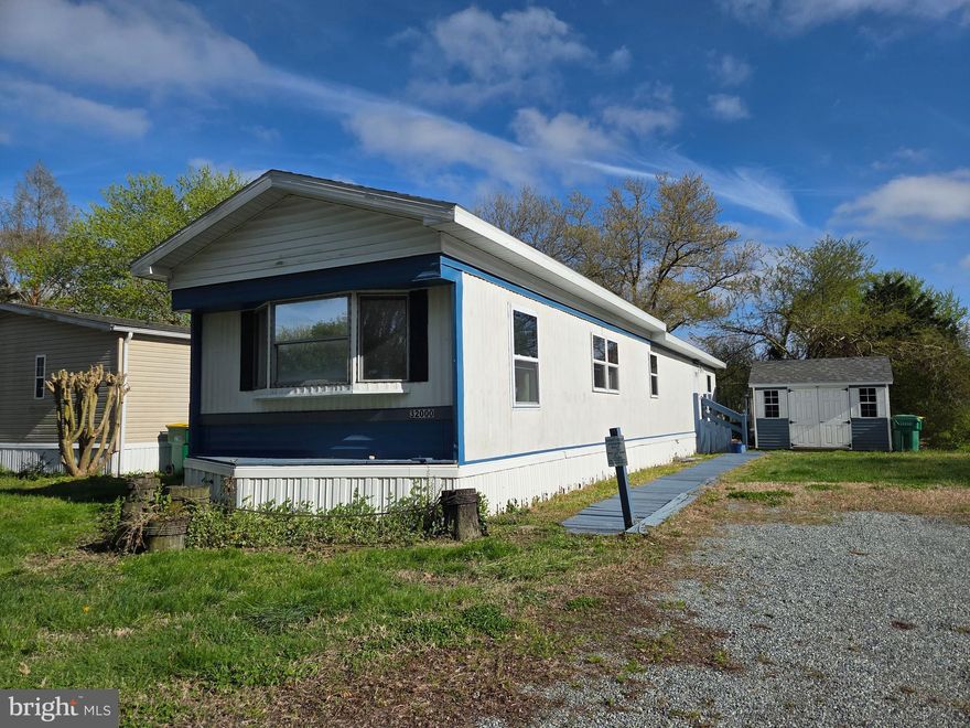 Welcome to this charming, fully furnished and beautifully decorated 3-bedroom home in Whispering Pines MHP, offering the perfect blend of comfort, space, and location—just about 15 minutes from Lewes Beach and Cape Henlopen!

You’ll love the functional split floorplan, with a spacious front bedroom large enough for a king-sized bed, while two additional bedrooms and a generously sized full bathroom are privately situated toward the back.

This home is being sold completely furnished—including all furniture, artwork, blinds, curtains, and wall décor—making it truly move-in ready or an ideal turn-key beach retreat. Recent updates add even more value, including NEW windows, NEW exterior doors, a beautiful A-frame roof (approx. 2018), and a heat pump installed around 2018 for efficient year-round comfort. Outside, enjoy convenient parking for two vehicles along with a handy storage shed—perfect for beach gear, tools, or extra storage.

The community offers fantastic amenities, including a pool, playground, and a large central green space. Even better, the lot rent includes lawn care and trash pickup, adding to the ease of living here. You’ll also appreciate the close proximity to shopping, including Redner’s.

This home presents a wonderful opportunity to personalize and make it your own while building value over time. With solid features, thoughtful updates, and a great location, it’s full of potential for a variety of uses—whether as a beach getaway, or full-time residence.

Park application required, with approval based on credit, background, and income or asset review.