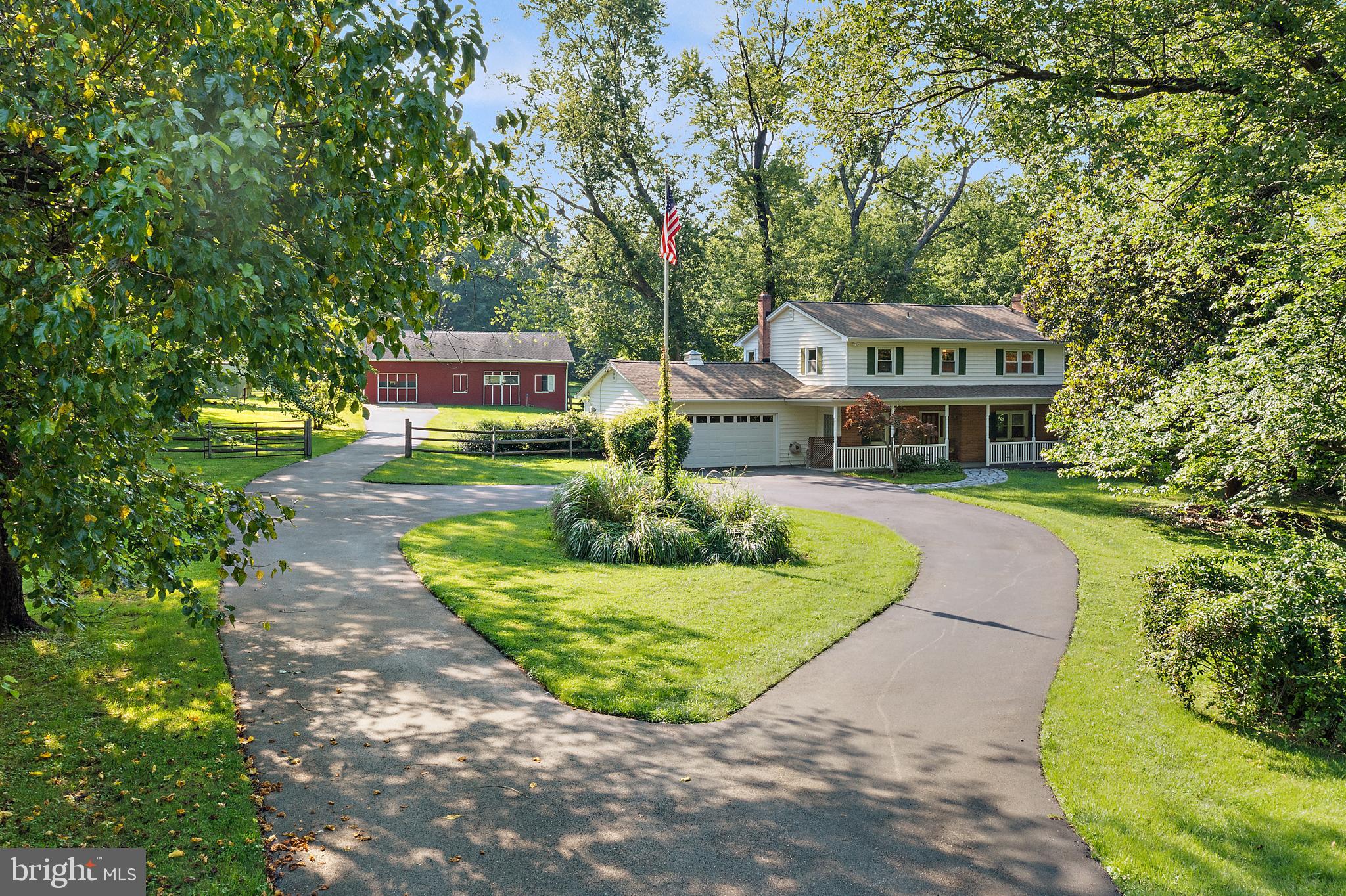 This is it! Tucked on a quiet street, this picturesque farmette offers open, flexible living and a serene country feeling close to everything. The heart of the home features a spacious great room and a beautifully updated kitchen with Kraftmaid cabinetry, stainless steel appliances, generous counter space, a walk-in pantry, and a sink overlooking the peaceful back fields. The cozy living room centers around a gas fireplace and opens to the dining area, where you can entertain and relax. Upstairs, the primary suite includes hardwood floors and a large walk-in closet. The home also has a whole-house propane generator (powered by a 500-gallon in-ground tank), adding peace of mind year-round. Outside, the attached two-car garage is complemented by a bonus garage at the barn. The cinderblock-constructed barn includes stalls, a tack room, hay loft, and access to a fenced pasture ready for your animals to roam or for living out your hobby farm dreams. And tucked in the back field - a charming pond with its own little island, adding to the tranquil ambience of this countryside oasis. All this, just minutes from major commuter routes, shopping, and restaurants, yet it feels like a world away.