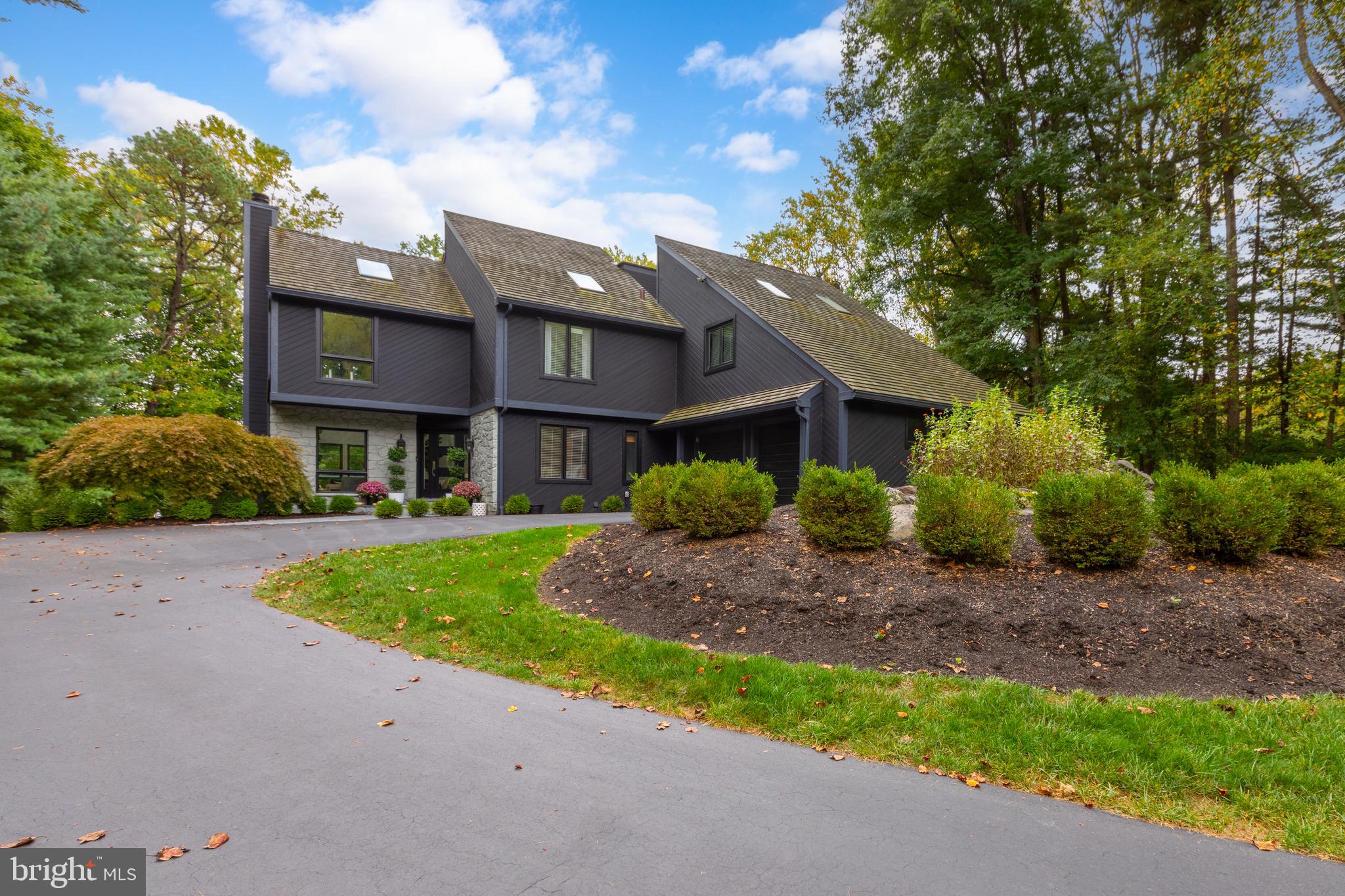 Introducing 5 Diamond Drive: a meticulously maintained and beautifully updated custom-built home, available now due to relocation. Nestled in the heart of Thornbury Township within the sought-after Dilworthtown Woods community, this 4-bedroom, 3-bath contemporary home offers a serene parklike setting on a wooded lot, with beautifully landscaped grounds surrounding an exquisite Anthony Sylvan pool.
This spacious home features an open-concept design, with an abundance of large windows and skylights that flood the space with natural light and maximize the ambiance of its tranquil location. Freshly painted bright white trim complements the timeless renovations, while white oak hardwood floors, recessed lighting, and elegant wood-framed windows add to the home’s inviting atmosphere.
Upon entering, a grand two-story foyer sets the tone for the tasteful updates throughout. The two-story living room, complete with a wood-burning fireplace, skylights and large windows overlooks endless views of the stunning backyard and pool. The centrally located dining room, highlighted by a modern pendant light and skylights, is perfect for entertaining. The upgraded kitchen showcases quartz countertops, wide white oak engineered hardwood flooring, a shiplap backsplash and accent wall, stainless steel appliances, an open pantry, and a chic garden sink. Two steps down from the kitchen, the breakfast nook boasts additional quartz countertop space, a large skylight, and decorative lighting, with access to the expansive deck overlooking the private backyard. A well-appointed guest bedroom, cozy family room, and recently renovated full bathroom complete the main level.
Upstairs, the home features three spacious bedrooms, including a primary suite complete with a walk-in closet, ensuite bathroom, and a private deck overlooking the backyard. Two additional expansive bedrooms with abundant closet space and vaulted ceilings with skylights share a renovated hall bathroom featuring a double sink and tub shower. The loft office space with built-in bookshelves offers a perfect spot for working from home.
The finished lower level is designed for entertaining, with a fabulous wet bar area that includes a wine refrigerator, separate beverage refrigerator, ice maker, dishwasher, and quartz countertops. Sliding glass doors lead to a charming patio and an outdoor oasis created by the pool and the surrounding lush landscaping - all perfect for relaxation and gatherings.
Additional highlights include 2 separate laundry areas, a newer central vacuum system, energy-efficient geothermal heating and cooling, a portable Generac house generator, and a cedar shingle roof with multiple skylights. Ideally situated near restaurants and upscale shopping within the highly acclaimed West Chester School District, this home is truly a gem. Schedule your showing today!