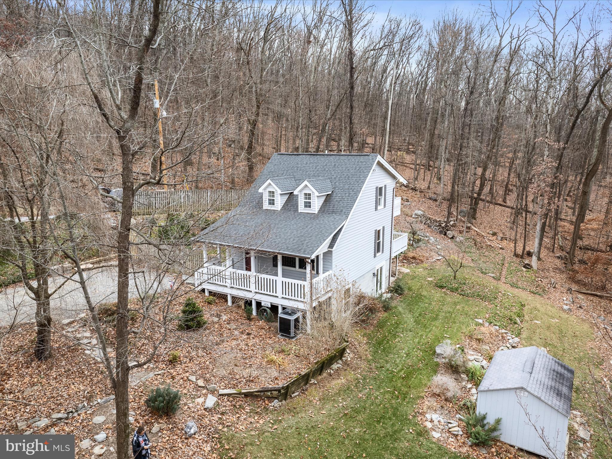 Tucked away on a quiet Harpers Ferry hillside sits this 3-level chalet within minutes of the Virginia and Maryland borders. The 1.4-acre lot contains three parcels with an ideal balance of cleared yard space with fencing and wooded privacy, plus the bonus of a valley view in the cooler months from the two-tiered balcony. The vaulted ceilings are so inviting, while the like-new kitchen draws you in with quartz counters, soft-close cabinets, a built-in pantry, and stainless steel appliances that include a double oven. The main floor also contains a bedroom/den and a recently remodeled full bathroom. Upstairs is the private and spacious primary bedroom, featuring plantation shutters and built-in shelving, with another full bathroom as well. The finished walkout lower level is equipped with the laundry facilities, a third bedroom/office, and a rec room that affords plenty of possibilities for additional space. With a 2023 HVAC system and a 2018 roof, what's not to love about this adorable home at such a great price point? Act now and get settled in by Christmas!