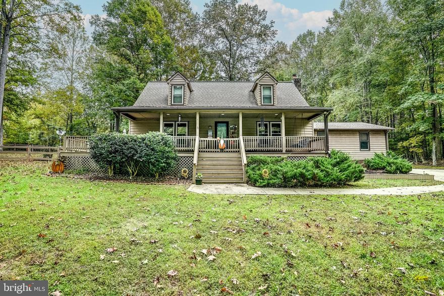 Lake living awaits you in this beautiful Lake Anna water access retreat with seasonal water views and within walking distance to the waterfront common area!  Located in Jerdone Island subdivision on the private side of the lake, this retreat features 4 bedrooms, 2.5 full baths (3 bedroom septic).  Assigned/leased boat slip #01 comes with this retreat.  This beautifully maintained lake home comes furnished and has a rental history (It made $22,776.45 from March 2023-October 2023)!  Open floor plan between the family room and kitchen that showcases hardwood flooring, a free standing gas stove for those chilly nights and a large eat-in kitchen.  All appliances convey!  The main level features two bedrooms, a full bath, mud room, laundry and half bath.  Upstairs there are two bedrooms and a full bath.  Two car attached side loading garage and a large detached shed perfect for storing your water toys, with a lean-to on each side that is large enough to store your boat! 
 Whether you are on the large covered front porch that wraps around to the side deck, roasting s'mores by the fire pit or spending the day on the lake; entertaining will be a breeze here!  Fully fenced in side yard, concrete and paved driveway and situated on a corner lot.  Everything about this property is simply gorgeous.  INVESTORS: Lake Anna was recently named the nation's TOP short term vacation "beach" rental location.  This retreat is also in a great location on Lake Anna close to Elk Creek County Store, dining and groceries!  See full list of improvements made to the property in MLS documents.