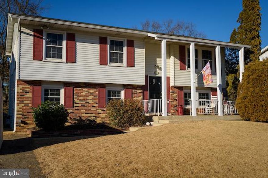 Pretty split foyer on the sunny side of the street. Featuring 3 bedrooms upstairs with new carpeting, hardwood flooring on the rest of main level. Large 42" solid wood cabinetry in kitchen, spacious walk-out deck  with stairs to back.  Freshly painted throughout. All new carpeting. Newer roof and gutter. Lower level features another bedroom, bathroom, laundry room and living area with walk-out basement leading out to large rear yard.