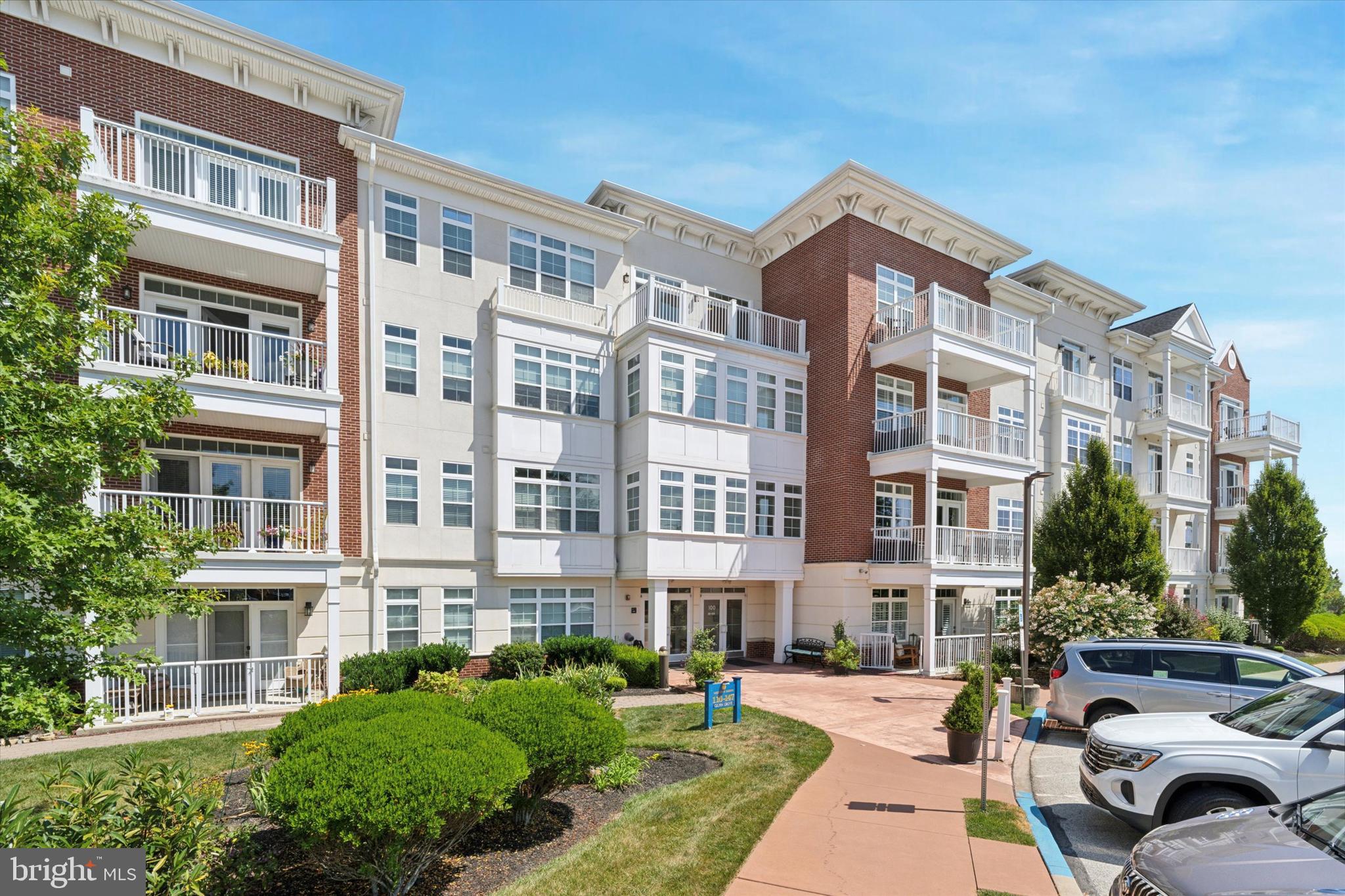 Welcome to Westtown Reserve, a premier 55+ luxury condominium community offering a relaxed and vibrant lifestyle. Whether you enjoy socializing with neighbors, staying active in the fitness room, strolling along landscaped trails, reading in the library, or relaxing in the outdoor Community Solarium and Terrace, there is truly something for everyone. Conveniently located just off Route 202 and minutes from the Borough of West Chester, this beautifully maintained first-floor, 2-bedroom, 2-bath condo is now available. The open-concept floor plan is ideal for entertaining and seamlessly extends to a private, picturesque second-story covered balcony. The designer kitchen is a chef’s delight, featuring upgraded granite countertops, a breakfast bar, custom glass tile backsplash, stainless steel appliances, under-cabinet lighting, and an oversized pantry. The main living area boasts wide-plank hardwood floors, crown molding, ceiling fans, and extensive recessed lighting. The inviting guest bedroom and full bath sit just down the hall, while the generously sized primary suite offers a private retreat with a sitting area, walk-in closet plus an additional closet, and a spa-like en suite bath with double vanity and walk-in shower. An oversized laundry room and extra storage closets add convenience. Each unit includes an assigned parking space and storage locker, with secure underground garage access, overhead entry, and 24-hour surveillance. Additional surface parking is available for guests. If you’re looking for low-maintenance, worry-free living in a stylish and welcoming community, schedule your private tour today! Note: Up to 20% of units may be occupied by residents under 55 (restrictions apply).