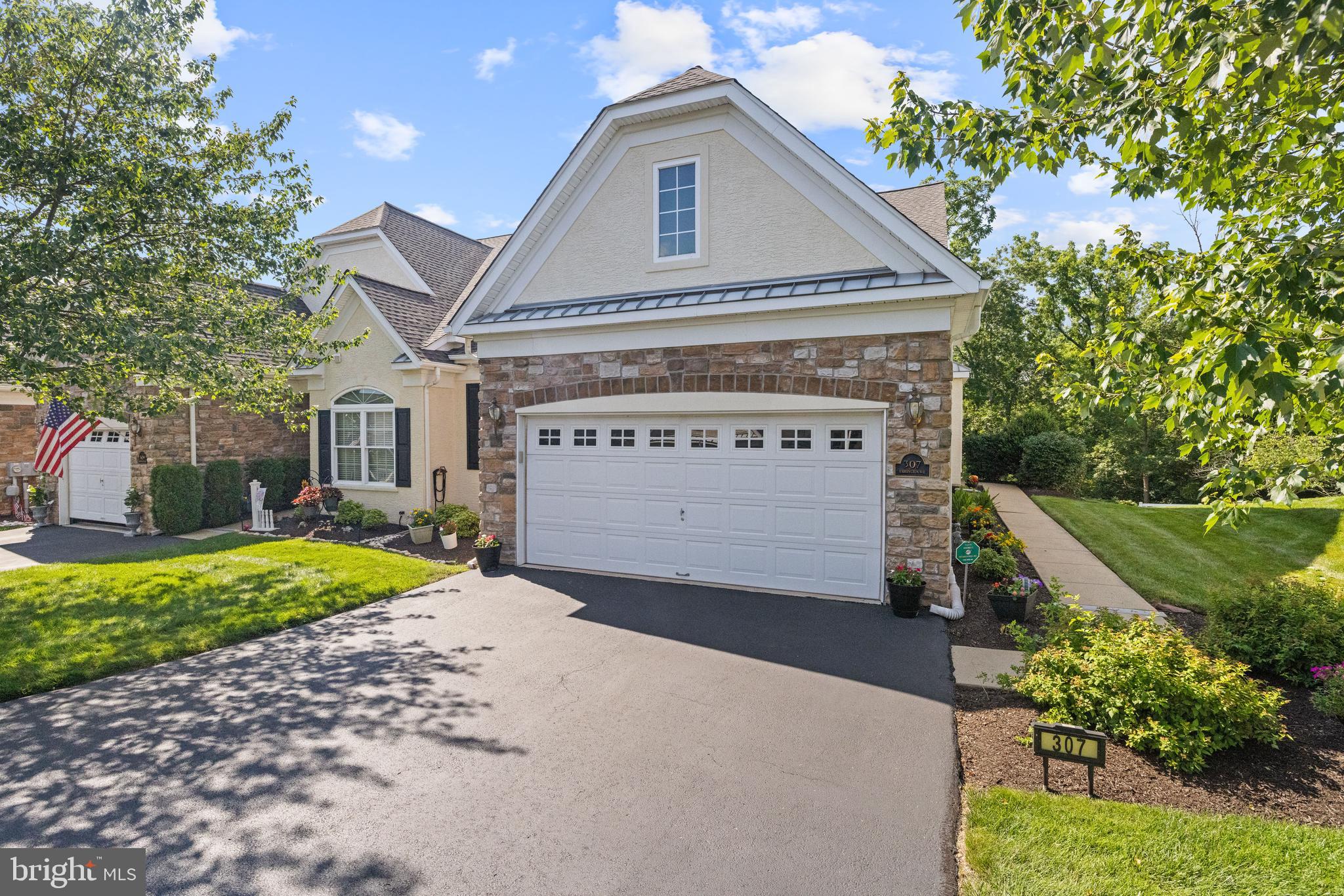 Welcome Home To 307 Harrington Way; First Time Offered By Original Owners, This Well Appointed END Carriage House In The Desirable HARRINGTON VILLAGE Community In Franconia Township (Souderton) Area; Inviting Hardwood Floor Entry With Half Wall & Chair Rail, Living Room With Cathedral Ceiling, Ceiling Fan, Chair Rail, Recessed Lights And Gas Fireplace, Dining Room With Tray Ceiling, Chair Rail, Crown Molding & Bump Out For Additional Storage, Elite Sunroom With Plenty Of Windows, Individual Wall Air Conditioning Unit And Sliders To Rear Deck, Primary Bedroom With 2 Walk In Closets And Primary Bathroom With Tile Floor, Double Vanity & Shower, Second Nice Size Bedroom With Ceiling Fan, Hall Bath With Single Vanity & Tub And Laundry Room With Inside Access To Large 2 Car Garage; Second Floor Finished Loft Offers HUGE Great Room With Ceiling Fan, Large Separate Sewing Room (Could Possibly Be A Third Bedroom But Needs Carpet And Does Not Have A Window) And A Full Bathroom With Single Vanity & Tub; The Beautifully Finished Area Of The Basement Includes A Large Recreation Room With Recessed Lights, A Game Room With Sliders To A Rear Paver Patio, A Very Nice Wet Bar Area With Wainscotting, Tile Floor, An Abundance Of Raised Panel Cabinets, Dishwasher, Wine Rack Perfect For Entertaining, And A Powder Room With Tile Floor And Vanity. There Is Also A Very Large Unfinished Area For Additional Storage With Poured Concrete Walls; Gas Hot Water Heater New In April 2018, New Gas Furnace & Air Conditioning In April 2024 And New Roof In November 2023; The Homeowners Association Covers Lawn & Landscape Service, Snow Removal From Driveways And Sidewalks To Your Front Door, Trash Removal And Upkeep To All Common Areas In The Village; The Spectacular Clubhouse Features Meeting Rooms, Full Kitchen, Gym, Game Room, Library & Pool Table; There Are Many Activities Offered By Our Social Committee, And The Community Is Conveniently Located Near Shopping, Entertainment, Banks, Drug Stores And Easy Access To Route 309 & Route 113; This Property Also Offers Premier Location In The Community Backing To Woods And The Walking Trail; Schedule Your Private Tour Today!