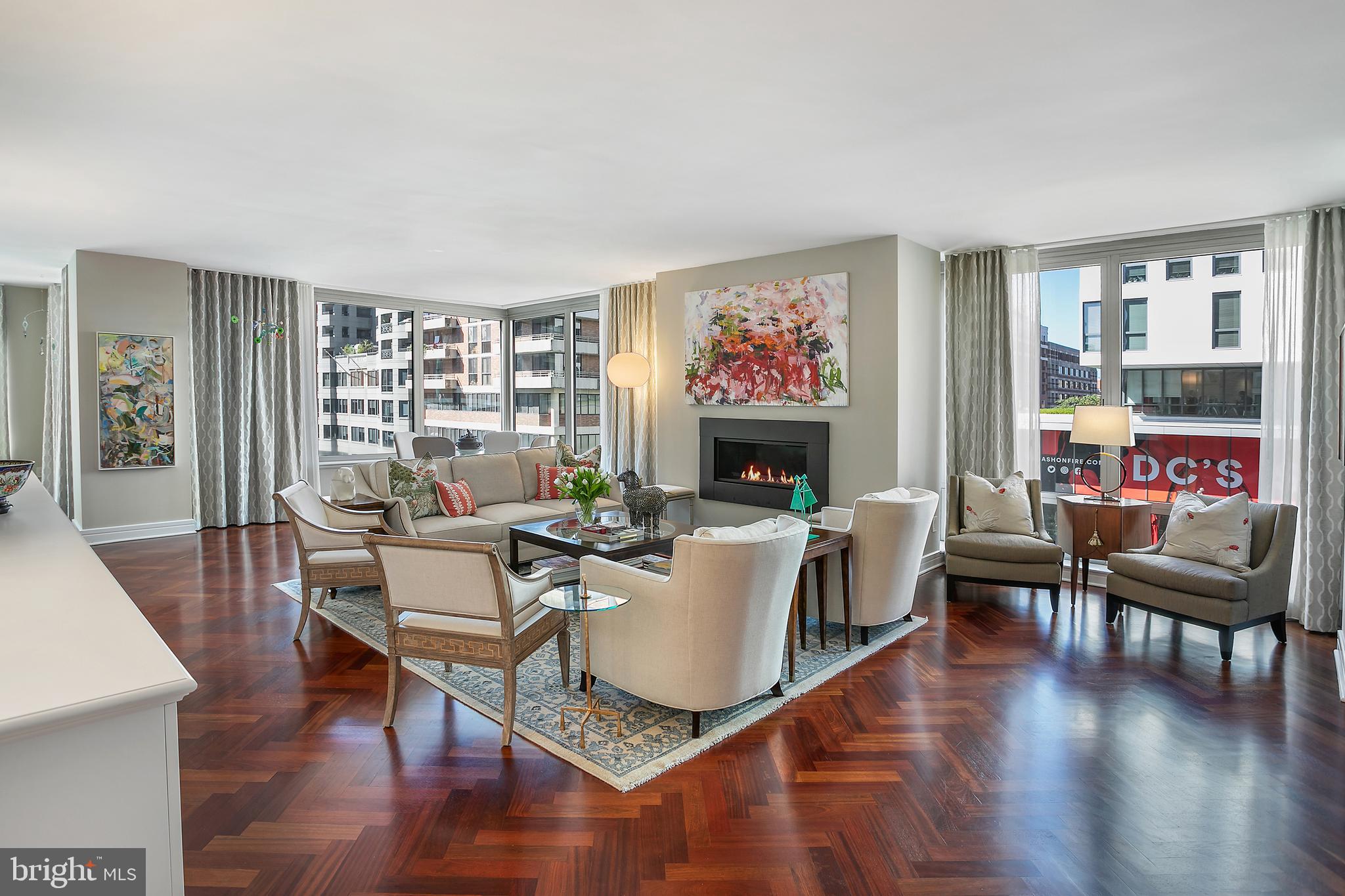 Experience luxury living at its finest in this stunning 3-bedroom 3.5-bath corner unit at the Ritz-Carlton Residences, boasting over 2,800 square feet of opulent space all on one level. This highly sought-after floorplan offers an abundance of natural light with windows wrapping around the entire residence. There was no expense spared in transforming this home into a true masterpiece. The brand-new kitchen is a chef's dream, featuring exquisite marble surfaces, top-of-the-line Sub-Zero and Wolf appliances, and elegant cabinetry complemented by brilliant lighting. The design of this residence offers the luxury of privacy, with bedrooms discretely situated in separate wings, providing a tranquil and private retreat for residents and guests. Every bathroom, including the powder room, has been completely remodeled to perfection with pristine white marble, Waterworks fixtures, Robern mirrors, and the pièce de résistance – a main suite that will take your breath away, complete with a stunning glass shower and a freestanding soaking tub. The cherry hardwood floors have been meticulously refinished with a satin walnut stain, and sumptuous carpeting graces the bedrooms for added comfort. Three parking spaces are included (one assigned and two pool spaces). As a resident of the Ritz-Carlton, you'll enjoy world-class amenities, including 24-hour concierge service, doormen, valet parking, guest parking, housekeeping, laundry and dry cleaning, catering, and the option for in-residence dining. Located in the highly desirable West End neighborhood, this building offers the ultimate in convenience, with fine dining and retail options at your doorstep. Trader Joe's, Whole Foods, parks, Downtown, and Georgetown are all within easy reach.