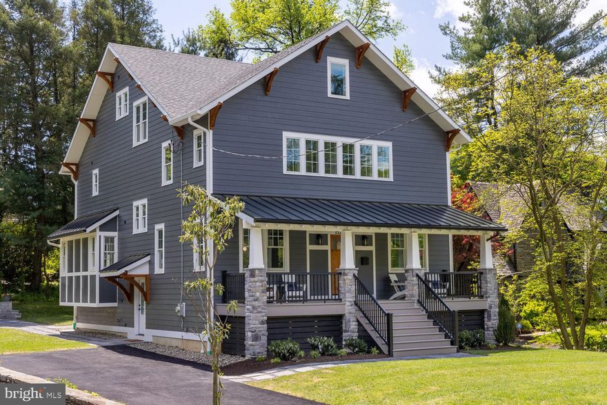 Nestled among the iconic homes of Swarthmore’s Ogden Avenue, a brand-new Craftsman style colonial awaits. Lovingly designed to fit perfectly into a neighborhood of architecturally compelling homes, 4 Ogden offers a wealth of conveniences that can only be found in a modern home, wrapped up in a package that sings with turn-of-the-century elegance. Mountain blue stone pavers lead up to the wide front steps onto the open porch. The Arts & Crafts front door opens to reveal the soaring ceilings, soft neutral colors, and rift sawn red oak floors found throughout the first floor. Noted local builder, R.S. Lee Construction, chose a theme of symmetry for the interior of 4 Ogden, which echoes throughout the house. A path of herringbone red oak with a walnut inlay defines the center hall in an otherwise open living space. To the right, the formal living room is filled with light from two pairs of windows. To the left, the formal dining room also offers two pairs of windows and a striking light fixture over the dining table space. Follow the herringbone path past a powder room with a glass bowl sink and fluted tile wall to the back of the house, where the enormous gourmet kitchen mirrors the light-filled open family room. The entire back wall of this open space is comprised of windows and French doors out to the great big screened porch and a vista of the lawn. The kitchen features Goebelwood custom white cabinetry with built-in pantries flanking the refrigerator. Quartz countertops, subway tile backsplash, and a porcelain farmhouse sink with a view over the lawn all add beauty. GE Monogram appliances include a 6-burner gas cooktop and double wall ovens. The massive island, with seating for five, provides a wonderful place to make memories. The open family room features a mini butler’s pantry with beverage fridge. The stunning gas fireplace is topped with a mantel of honed granite and flanked by built-ins. A large office with a stunning bank of wraparound windows completes the first floor. Upstairs, the primary suite features a spacious bedroom with a professionally organized walk-in closet, and French doors to a private balcony overlooking the lawn. From the heated porcelain tile floor, marble-topped double storage vanity, and glass door stall shower with shower head and handheld shower, to the gorgeous oversized soaking tub, the sumptuous primary en suite bath feels like a private spa. Two additional spacious bedrooms, a full hall bath with subway tile surround, and a laundry room complete the second floor. The full third floor includes a fourth bedroom, a full hall bath, and a spacious additional room, currently set up as a playroom/second family room. This enormous space boasts a bank of windows with a window seat spanning the length of the side wall. The finished lower-level is mostly above grade, with bright windows, and includes a rec room with a great big dry bar. Ideal for big parties, there is plenty of space for a sectional sofa on each side of the bar. A fifth bedroom may be found on this level, along with an en suite bath. Custom cubbies by the outside door will help to keep the whole house tidy. Built with efficiency and comfort in mind, 4 Ogden features both spray and batt insulation, tankless hot water heater, and two heat-pump systems with gas back-up, one for the lower level and 1st floor, one for the 2nd and 3rd floors. Outside, a mountain blue paver patio is sheltered by a stepped terrace wall, and provides the perfect setting for cookouts and quiet evenings. Served by Wallingford-Swarthmore schools, 4 Ogden is located just blocks from the swim club, Swarthmore-Rutledge school, village shops, library and train station. The Philadelphia International Airport is just 20 minutes away by car, and downtown Philadelphia may be reached in 30 minutes by car or train. Generous space, authentic Craftsman charm, comfortable efficiency, and a prestigious location all combine to give luxury to everyday living at 4 Ogden Avenue.