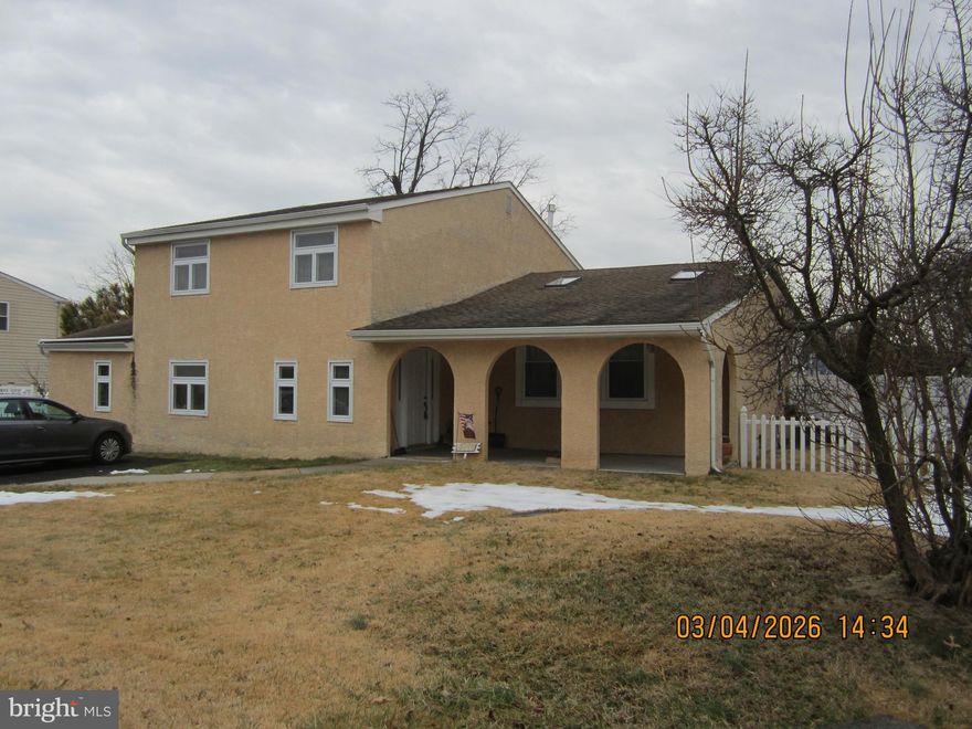 Huge 4 Bedroom, 2 1/2 bath, split level situated on a corner lot in the desirable Neshaminy Valley neighborhood.  An estimated 2350 sq ft includes a converted garage space into a large family room.   Enter the home through the arched front porch area into a tastefully tiled foyer space.  First level is tiled throughout.  To the right, up a half level is a high ceiling living room with patterned hardwood floors, wood-burning fireplace on a stone facade wall, 2 skylights, and an updated bay window.  Through to the dining room with natural light on 2 sides and back yard access.  Continue to the upgraded kitchen with plenty of cabinetry, tile flooring and gas stove.  From the kitchen down to the original family room  flooded with natural light, ceiling fan, and 2 access doors to back and side yards.  This room requires some drywall work.   Then to the huge, 2nd family room, formerly the garage.  It is conditioned with a separate mini-split system and also has a gas fireplace.  Also on this level is a half bath and laundry room with outside access.  Second level is carpeted, includes primary BR with 3 piece bathroom, 3 other BR's and a full bath.  Outside the back yard is fenced with access to the detached 1 car garage.  There is also an in-ground swimming pool though it has not been functional for several seasons.  Mechanicals are solid includes Central Air, gas fired heater and water heater.  The convertedRoof installed in 2018.  Easy to show.