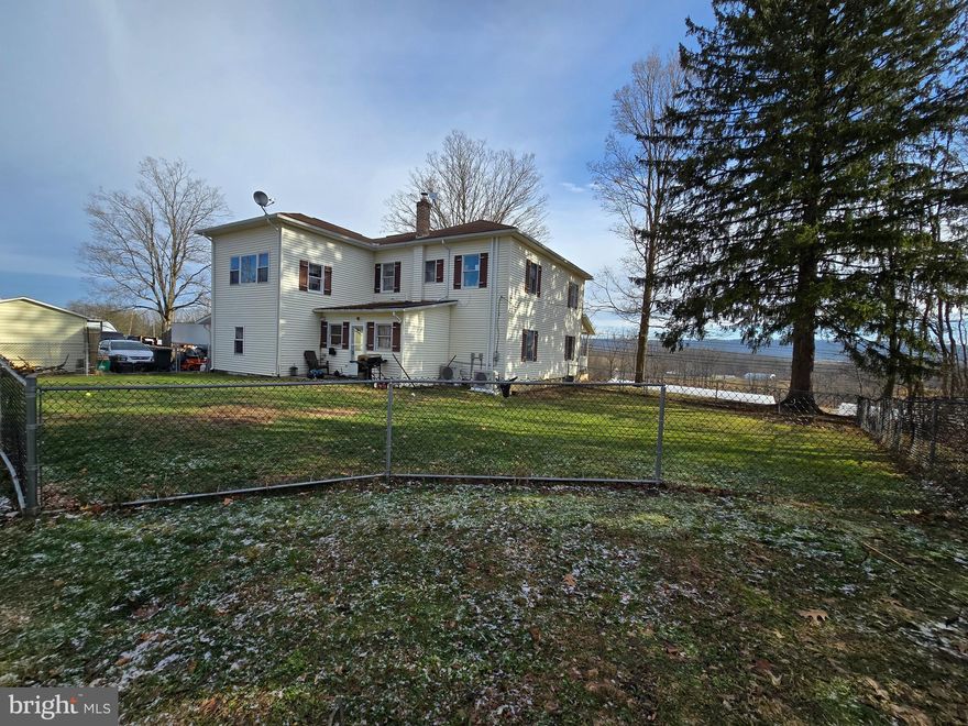 Discover timeless charm and scenic beauty in this traditional two-story home located in the picturesque village of Millheim. Set on a 1.06-acre lot, this property offers over 2,000 square feet of living space with four bedrooms and one and a half bathrooms, blending classic architecture with thoughtful modern updates.  A standout feature of the home is the expansive wraparound porch, where sweeping front and rear views of the surrounding mountainsides create a peaceful backdrop for morning coffee or evening relaxation. The setting offers a sense of space and privacy while still being conveniently close to local shops, dining, and community events. Inside, the home showcases original hardwood floors, updated kitcehn with granite counters and S/S appliances, high ceilings, and stunning woodwork that reflect its traditional craftsmanship. Natural light fills the living spaces, enhancing the warmth and character found throughout. Updates completed during the current ownership complement the original features while supporting everyday comfort. The flexible floor plan includes a generously sized bonus room, ideal for a home office, creative studio, reading room, or additional gathering space. The recently installed heat pump provides efficient heating and central air conditioning, adding modern convenience to this classic residence. With its combination of historic appeal, functional living space, and beautiful mountain views, this property presents a unique opportunity to own a well-maintained home in one of Central Pennsylvania’s most charming communities. Schedule your private showing to fully appreciate the character, setting, and potential of this inviting Millheim home. And approximately 30 minutes to State College & Penn State University.