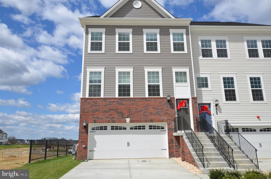 Brand new spacious and bright end unit townhome, is the largest model located on a premium lot in Patapsco Glen new community. 3 above grade levels. Front entry 2-car garage, with 240V Fast EV Charge Port Installed in garage for your convenience! Large driveway can park more cars. Ground Level has 4th bedroom, and 3rd full bath. Main level kitchen with stainless steel appliances, extra large island, marble counter tops. Living, dining room combo. Half bath. Sliding door off living room leading to large deck. Upper level with 3 bedrooms 2 full baths, with upgrade vanities, large ceramic shower and floor, washer & dryer. Extra wide stairs and hallway. Great view from front and rear windows. Faux wood blinds on all windows. Abundant of lighting through-out the whole house. Plenty of parking space. Be the first to Occupy this brand new home! Please remove shoes during showing.