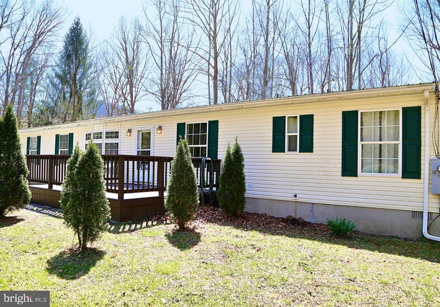 Located on the banks of the Lost River, this charming 4-bedroom, 2-bath ranch offers both convenience and tranquility. Just half a mile from Corridor H, it provides easy access while maintaining a peaceful, secluded feel.

Inside, you'll find upgraded flooring throughout. The living room, just off the front door, offers ample space for gathering. Adjacent to the living room, the spacious primary suite includes a private study/sitting area and a walk-in closet that connects to the ensuite bath. The primary bath features a stand-up shower, jacuzzi, and double vanity sinks.

On the opposite side of the home, three generously sized bedrooms—each with walk-in closets—share a full bath with a tub/shower combo. A second den/family area offers versatility and connects the bedrooms to the kitchen and dining area.

The bright kitchen boasts an eat-in island, abundant cabinet storage, and an open layout leading into the dining area. Just off the kitchen, a convenient utility room includes laundry, additional storage, a utility sink, and a back door for easy outdoor access.

The true highlight of this property is its location. Step onto the recently upgraded rear deck, complete with a new awning, and savor your morning coffee or evening drinks while listening to the soothing sounds of the river. Then, grab your fishing poles or kayak and enjoy the best that West Virginia has to offer with direct, private access to the Lost River.

With high-speed fiber optic internet and just a two-hour drive from DC, this home offers the perfect blend of quiet living and connectivity. Schedule your tour today!