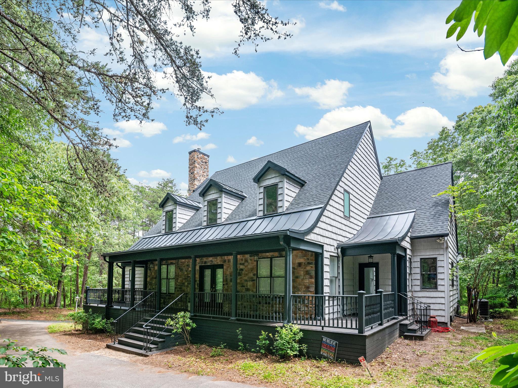 This large, spectacular waterfront home, with over 3,800 square feet of living space (and potential for more expansion within the home’s original footprint) somehow still manages to exude a charming “cottage in the woods” kind of feeling. The property extends over 6.03 partially wooded acres in the quiet North Shore community of Pasadena. It has shallow water frontage on Grays Creek with a 70-foot dock and water views from two sides. Originally built to classic Southern Living plans, this modern cottage has been completely re-imagined and thoughtfully renovated from top to bottom. The owners have created a beautifully modern, environmentally friendly, secure family estate. Upgrades are almost too numerous to list them all!
Hardwood floors extend to all three levels. The primary bedroom’s en suite bath was completely renovated and includes heated marble floors and a garden tub. The kitchen has new granite countertops and stainless steel Kitchen Aid appliances. The custom-designed hardwood staircase in the central corridor creates an elegant anchor to the main level. Upstairs, both bathrooms were renovated, including an extensive redesign of the hall bathroom.
Energy efficient and cozy pellet stoves add heat to the primary bedroom, the living room, and the garage/workshop. The pellet stoves provide backup heat on cold nights in addition to the central HVAC system and the geothermal heating and cooling systems. Foam insulation was added into the second floor walls and the attic. In the attic—a huge space with ample headroom—a new HVAC system was added. Thus the attic is now a conditioned, insulated space, already wired and ready to be converted to additional living space or provide climate-safe storage. The asphalt roof was fully replaced in 2022, with metal dormers added as well as metal sections where the roof profile curves towards the horizon, which will enhance the long-term waterproofing of the roof system.
The basement has two layers of 3/4” sheet rock for sound insulation, perfect for action-packed movie nights in the recently finished screening room. Just off the screening room is another space that was designated in the original plans to be a wine cellar. Three new heavily insulated garage doors were also added, as well as a dedicated power supply for whatever car charger a new buyer might wish to install. A large deck off the back of the house was rebuilt with underpinnings and storage underneath. The deck has views of the water and woods, as well as a hot tub. The owners also completely redesigned and replaced the front porch to create one big, elegant wraparound porch.
The owners enjoy a water doctor water system that purifies water with no chemicals (replacing the original chemical-based system), as well as a redundant reverse osmosis system for drinking water. An open lawn behind the house was originally slated for a detached three-gar garage with a second-story living space. The current three-car garage and workshop had originally been conceived as a 1100-square-foot au pair suite.
Six security light poles and 54 cameras provide significant security around the property. They also provide six sets of outdoor outlets and, to keep it fun, each pole is equipped with an outdoor sound system! Perfect for summer parties, the music extends all the way to the 400-square-foot outdoor dance floor next to the dock! The dance floor was refreshed this spring with drainage improvements and fresh paint. The 70-foot dock provides perfect water access for canoes, kayaks, SUPS and catamarans. It also offers priceless views of the birds, fish and shoreline of this slice of paradise on Gray’s Creek.
The voluntary North Shore neighborhood association includes access to a private marina and boat ramp and a community beach. It is rare to find a property like this, one that has been massively upgraded and improved from its original plans, and yet still has so many more possibilities for future plans and generations.