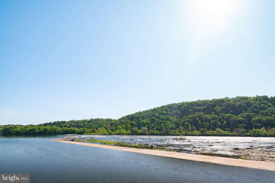 This Exceptional Waterworks Residence Offers Magnificent River Views, Has Been Restored By An Architect And Professionally Designed Throughout. This Sensational Offering Is Situated In The Original Solid Stone Historic Mill Structure With Only Four Individual Residences. Original Details Of The Building Have Been Preserved And Include Uniquely High Ceilings Throughout, Two-Story Brick Walls Designed With Arches To Match The Building’s Exterior Arches, Refurbished Wood On Many Of Its Random Angled Ceilings And A Custom Fabricated Floating Wood And Metal Staircase Including Wood And Leather Detailed Newel Posts Is Located In The Entrance Hall Accessing The Second Level. The Great Room Features Gorgeous River Views From Oversized New Windows And Atrium Doors To A Juliet Balcony With Views Towards The New Hope-Lambertville Bridge. Customized Duchateau Engineered Hardwood Floors, Solid Wood Doors, Recessed Lighting And High-End Designer Lighting Fixtures Throughout. A Large Metal Surround Acid-Dipped Steel Hearth Cabinet Sterno Fireplace Is Located In The Great Room As Well As A Continuation Of Brick Walls With Arched Design. A Generous Dining Room Features A Stunning Overhead Light Fixture Surrounded By A Customized Detailed Framed Mirrored Ceiling Mount. The Gourmet Kitchen Offers Sueded Granite Countertops, A Wide Breakfast Bar, Separate Stove Top With A Brick Wall Containing A Bronze Hood Vented To The Exterior, Stainless Steel Oven, Copper Sink And A Dishwasher And French Door Refrigerator Designed to Blend With The Professional Cabinetry Throughout. All Appliances Specially Upgraded. The Main Level Also Includes Laundry With A Built-In Counter Above Side By Side Appliances, A Powder Room And A Second Bedroom Currently Used As A Den/Office With Ensuite Bath. This Bath Includes A Large Glass Enclosed Shower With Specially Designed Walls And Shower Flooring. The Second Level Features An Alluring Primary Bedroom With Riverview Windows Surrounding. Brick Walls Continue Up The Staircase And A Separate Hall Leads To A Walk-In Closet. A Luxurious Primary Bath Accessed Through Reclaimed Sliding Barn Doors Includes A Custom Cement Tub, Full Walled Large Glass Enclosed Shower, Double Vanity, Full Brick Wall With Circular Mirror, Custom Designed Lightly Frosted Interior Oval Window And A View From Its Long Narrow Window Overlooking The Delaware. This One Of A Kind Waterworks Residence Has Beautifully Realized An Interior That Is In Unison With Its Home In The Original Historic Paper Mill Factory. Two Car Side By Side Parking In Secured Garage Below. Superb Location. Walk To Town. Next Door To Odette’s Riverhouse. All Appointments Through And Accompanied By Listing Agent.