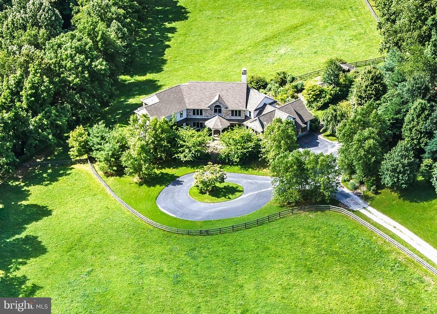 Set on 23+ acres in one of Chester County’s most sought-after locations, this remarkable property combines a picturesque country setting with a custom home designed for comfort, elegance, and recreation. Privately sited and surrounded by open space that abuts the 1,263-acre ChesLen Preserve, the residence offers 5 bedrooms, 4 full and 2 half baths, and exceptional equestrian facilities.
The home’s open floor plan is filled with natural light and designed to capture stunning views and southern exposure. Main Level highlights include magnificent reclaimed wood and antique heart pine floors, a Great Room with a wood-burning fireplace and bucolic vistas over the pastures, and a large Office with fireplace that could also serve as a first floor Guest Suite. The Upper Level features a Japanese-inspired Primary Suite with Shoji screens as dividers, plus four additional Bedrooms and two full bathrooms, including a suite well-suited for an Au Pair or guests.
The fully finished Lower Level is an entertainer’s dream, complete with an expansive Indoor Pool, Game Area, second Kitchen, Exercise Room, full Bath, and Sauna.
For equestrian pursuits, the property features a 4-stall Barn with Wash Stall, Feed and Tack Rooms, four pastures, a round pen, and a 100' x 170' Riding Ring with exceptional footing. Additional highlights include a scenic pond and beautifully landscaped grounds.
Built and maintained to the highest standard, this exceptional property is located between Marshallton and Unionville in Radnor’s Brandywine Hunt Country and the award-winning Unionville-Chadds Ford School District, with convenient access to West Chester, Kennett Square, Wilmington, the Route 202 corridor, and trains to Philadelphia and New York.