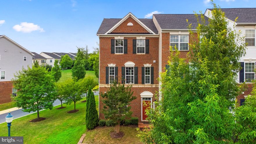 Stately brick front end-of-group townhome situated in desirable Greenway Village  features an architectural shingle roof, a neutral color palette, an inviting hardwood foyer entry, a family room or study, a half bath, access to the garage, and stairs to the core living spaces. The open main level boasts gleaming handscraped hardwoods, large profile crown moldings, a stunning living room with a trio of sparkling windows, an open dining room accentuated by wainscoting with an elevated breakfast bar overlooking a well-appointed kitchen. An epicurean delight, the gourmet kitchen showcases a stainless steel appliance suite, 42" maple  cabinetry, sleek granite counters, a center island with a breakfast bar, and a casual entertaining space with a glass slider to a low maintenance deck. Owner's suite presents a walk-in closet, a vaulted ceiling, and a private bath with a dual sink vanity, and a glass enclosed shower. Community amenities include a clubhouse, 2 pools, playgrounds, basketball courts, covered picnic area, and easy access to shopping, dining, and commuter routes.