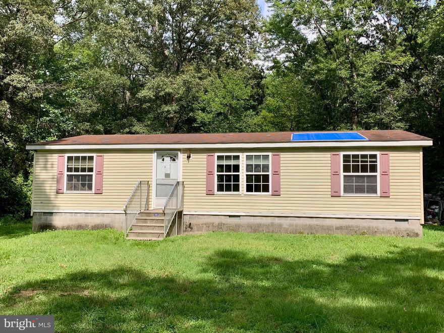 If you are seeking seclusion in a rural setting, this is the home for you!  3 bedroom, 2 bathroom Class C doublewide on a 3.30 +/- acre, mostly wooded parcel.  Located approximately 15 miles from the Dover Air Force Base and approximately 45 miles from the beach and Atlantic Ocean in Lewes and Rehoboth Beach.  Property is being sold in as-is condition.  Bank approved short sale.  All offers responded to within 24-48 hours.