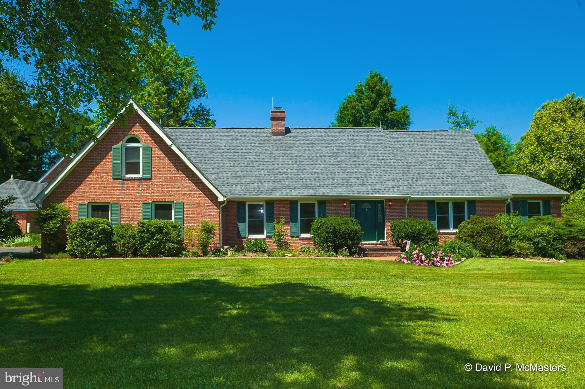 HUGE PRICE REDUCTION!! VERY MOTIVATED SELLER!! THIS 4000 square foot BRICK Cape Cod in the very DESIRABLE UVILLA ESTATES SUBDIVISION. Located between HARPERS FERRY AND SHEPHERDSTOWN and minutes from RT 340 leading to FREDERICK, MD AND 270 TO THE DC METRO AREA, AS WELL AS I-70 TO BALTIMORE. 3 International airports are within 1-1.5 HOURS driving. The local features include HARPERS FERRY NATIONAL PARK, SHEPHERD UNIVERSITY, CHARLES TOWN RACING AND CASINO, 2 RIVERS FOR FISHING / TUBING AND KAYAKING and a GREAT OUTDOOR for hiking, camping, biking and just relaxing.
THIS SPACIOUS and well maintained home that has been LOVED by the current owners for 23 years. entering the living room with its VAULTED CEILING and PELLET STOVE gives you chance to start unwinding and living the WEST VIRGINIA life. Leading to the gorgeous COUNTRY KITCHEN, a den then to a TREX REAR PORCH that is a SPECIAL part of this home. RELAXING AND SO VERY PRIVATE for STARGAZING, reading, entertaining and just being yourselves. THE MAIN LEVEL PRIMARY BEDROOM has direct access to the deck and an adjoining OFFICE.
The upper level contains 2 BEDROOMS with UPGRADED JACK N JILL BATHS and a wonderful BONUS FAMILY ROOM above the attached 2 car garage.
Outside the detached 1 car garage is currently used to house lawn and garden equipment, but is big enough for a small car. THE OVER SIZED DETACHED NEARLY 900 SQ FT 2-BAY GARAGE is car enthusiast's DREAM with plumbing capacity for a bath. ABOVE THE GARAGE is spacious additional storage AND CLIMATE CONTROLLED HOBBY ROOM.
THE PAVED driveway is LINED WITH A BEAUTIFUL ASSORTMENT of trees, some of which are FLOWERING and the rear yard is also complimented with A VARIETY OF LOVELY TREES.
WHAT A COMPLETE PACKAGE THIS PROPERTY IS !!
