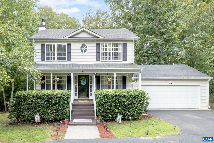 Spacious 3 bedroom colonial is filled with special features and upgrades! HARDWOOD FLOORS throughout the main level, GRANITE COUNTERTOPS, huge FENCED BACK YARD, 2 car GARAGE, woodburning FIREPLACE, DUAL ZONE heat pumps and more. There are endless uses for the full sized climate controlled "crawl" space with concrete floor: think man cave, workshop, hobby room or just extra storage! Enjoy the outdoors from multiple spots: a rocking chair on the full front porch, grilling on the rear deck, relaxing in the inflatable hot tub on the covered patio or sit by the fire pit on a chilly fall evening. There's plenty of room for a crowd  inside too with a huge 27x12 living room, sunny white kitchen featuring center island with seating that's open to a spacious dining area. Upstairs are 3 large bedrooms including owners suite with a vaulted ceiling and luxury bathroom with a garden tub and separate shower. There's even plenty of parking with a circular paved driveway (plus 2 car garage) and its located just 5 minutes from shopping and restaurants, and access to all the amenities Lake Monticello has to offer! 350 acre lake, 18 hole golf course, 5 beaches, resort style pool and so much more!,Granite Counter,White Cabinets,Fireplace in Living Room