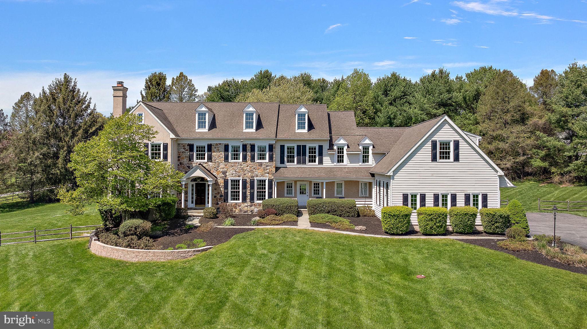 Poised on a beautifully landscaped 2.6-acre lot, this custom-built estate offers over 7,000 square feet of living space, featuring 5 bedrooms, 5 full baths, and 2 elegant powder rooms.
From the moment you enter the grand front-to-back foyer, the home's meticulous craftsmanship is evident. To one side, a refined formal living room is anchored by an elegant fireplace, while the opposite side reveals a formal dining room enhanced with a brand-new, designer butler’s pantry—setting the tone for effortless entertaining. The heart of the home is a stunning, gourmet kitchen, showcasing an expansive quartz island and backsplash, custom range hood, high-end stainless steel appliances, and a built-in warming drawer. Bathed in natural light, the morning room and soaring two-story family room—complete with a floor-to-ceiling stone fireplace—offer an open, airy ambiance perfect for both intimate gatherings and large-scale entertaining.
Step outside to a Belgian block patio and take in sweeping, tree-lined views of Chester County—an idyllic backdrop for morning coffee or evening soirées. Completing the first floor also is private home office, two thoughtfully updated powder rooms, a chic mudroom/laundry area, and access to the oversized three-car garage.
Upstairs, the luxurious primary suite awaits featuring a tray ceiling, a spacious sitting room, and dual walk-in closets. The ensuite bath boasts two vanities, a soaking tub, and glass shower. Two additional bedrooms share a Jack-and-Jill bath, while a separate princess suite enjoys its own private ensuite. A rare find is the guest suite with a large bedroom, private living area, and full bath—perfect for multigenerational living or extended guests. Last, a full walk-up third floor offers flexible space ready to adapt to your evolving lifestyle.
The finished walkout lower level is complete with a home theater setup, a full bath, kitchenette, and expansive living area—ideal for game nights, celebrations, or relaxing weekends at home.
Tucked away in an exclusive, ten-home neighborhood within the award-winning Great Valley School District, this extraordinary home offers the perfect balance of serenity and convenience. Enjoy easy access to the PA Turnpike, fine dining in the Malvern Borough, and the scenic trails of Brightside Farm Park just minutes away. Schedule your private showing today and experience the lifestyle you deserve.