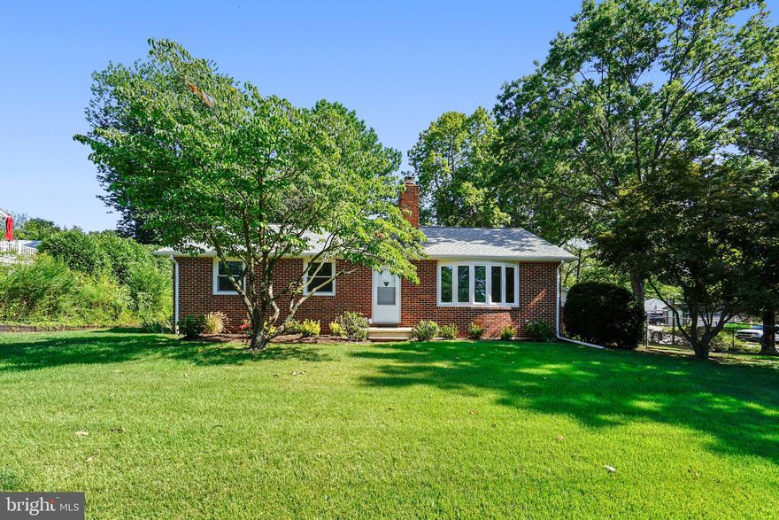 Welcome home to this recently renovated brick Rancher in Severn! Situated on over a third of an acre, this large corner lot features a detached two car drive-through garage plus a carport. Entering the home, you step foot onto finely finished oak hardwood floors that run throughout the main level. The bright and inviting Kitchen reveals shaker style white cabinets, butcher block countertops, and a stainless steel appliance package. The adjacent dining area expands onto a fully screened porch that delivers private views of the rear garden. The main level Master Bedroom with ensuite full bath benefits from a custom-sized tile shower and all new fixtures. The lower level provides a spacious, yet cozy den with a pellet stove and brick hearth, a large workshop, and an additional bonus room or office space. The laundry room comes equipped with a washer and dryer, a second refrigerator/freezer, and a utility sink. Multiple storage rooms, closets, and built-in shelving units make efficient storage solutions out of normally unusable space. Conveniently located near Telegraph Road and Route 32 makes commuting to Fort Meade or BWI a breeze. This turnkey home is move-in ready! VA and FHA loans welcome.