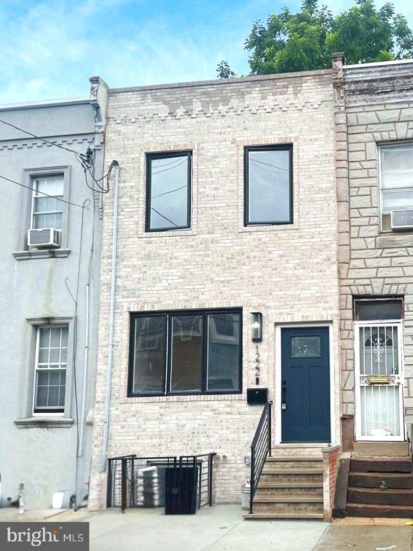 Welcome to 1222 S 26th St, located in the popular Grays Ferry neighborhood, just steps away from Washington Ave. This beautifully renovated home blends modern style with charming character. From the moment you step inside, you'll love the open floor plan featuring a bright living and dining area, and gorgeous kitchen with island, built-in wine cooler, and high-end KitchenAid appliances! The exposed brick walls add warmth and urban flair throughout the house. Upstairs, you'll find three bedrooms and a lovely full bathroom. The spacious primary bedroom boasts large windows and exposed brick for a cozy yet airy feel. The back bedroom features a generous closet and plenty of natural light, while the middle room is perfect for a home office, study, or playroom. The FINISHED basement includes a laundry area with a laundry sink and offers the potential to create another bedroom, entertainment space, or workout area, tailored to your needs. Don't miss this opportunity to own a stylish, move-in-ready home in a convenient location close to dining, shopping, and public transportation. Conveniently located to the University of Pennsylvania, CHOP, Jefferson Hospital, Center City and I-76. Come see it for yourself!