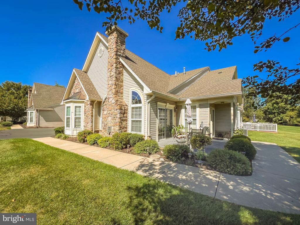 This beautiful Rosewell Model is perfectly positioned on a private back lot in the highly sought-after 55+ premier community of The Villas of Shady Brook. From the moment you arrive, the back entrance welcomes you with a spacious patio — the ideal spot to relax and unwind while overlooking the serene backdrop of mature trees. Step inside to a bright entrance hall that flows seamlessly into both the great room and the den. The den, often used as a home office or sunroom, offers peaceful views of the open yard, making it a cozy retreat for work or relaxation. The open-concept layout creates a natural gathering space where the kitchen, dining room, and living room connect harmoniously — perfect for entertaining family and friends. The living room features a gas fireplace framed by two charming sunburst windows, while sliders to the patio flood the space with natural light. The dining area easily accommodates a formal table for hosting special occasions. The eat-in kitchen boasts plentiful white cabinetry, gas cooking, solid surface countertops, and a large pantry that provides valuable extra storage. While this home expresses the sellers palette , it’s ready for you to add your personal style and favorite colors. A customized interior layout provides additional square footage not typically found in this model. The primary suite is highlighted by a tray ceiling and a triple walk-in window well, creating the perfect nook for a reading chair or a quiet retreat. The en-suite bath includes a walk-in shower, double sinks, and its own linen closet for convenience. The second bedroom is generously sized and filled with natural light, while a versatile bonus room can easily serve as an additional office, hobby space, or guest area. Upstairs, the loft suite — accessed through the laundry room — features a full bath with a stall shower, making it ideal for overnight guests, a private office, a gym, or anything your lifestyle demands. The sellers also thoughtfully added a large walk-in storage area for maximum functionality. Additional highlights include a two-car garage, an exclusive back-lot location, and access to an incredible array of resort-style amenities. At Shady Brook, every day feels like adult camp — enjoy pickleball, bocce, Mah Jong, canasta, guest speakers, lively parties, engaging events, and both indoor and outdoor pools.
This home truly offers the perfect blend of comfort, community, and convenience — whether you’re ready to retire in style or simply enjoy a relaxing lifestyle after a busy day. Don’t miss this rare opportunity to call this beautiful retreat your own!