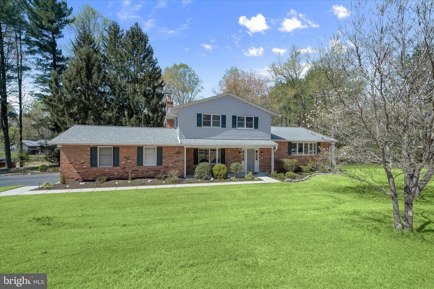 Beautiful split-level home set on a premium 2.99-acre lot in Ellicott City's sought after Fox Den Farms community. Notable updates include siding, roof, light fixtures, family room door, HVAC, and a water treatment system, offering both comfort and peace of mind.  A covered front porch welcomes you inside to a sun filled floor plan with living and dining rooms, along with the kitchen, all highlighted by hardwood flooring. The spacious kitchen features Corian countertops, wood cabinetry, and a breakfast nook, with stairs leading down to a step-down family room anchored by a stove set within a brick fireplace surround. From here, enjoy access to the screened porch and attached garage.  Upstairs, the primary bedroom suite offers a private bath, accompanied by three additional bedrooms and a full hall bathroom. The entry level includes a versatile bedroom and half bath, ideal for guests or a home office.  The lower level provides a finished walkout bonus room and abundant storage space. Outside, the landscaped lot, two-car garage, and expansive driveway complete this exceptional property.  Ideally located near major commuter routes, shopping, dining, and entertainment options, this home offers space, updates, and a sought-after setting.