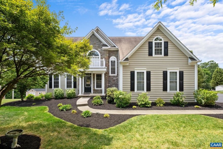 This home is ready for you! Located close to the community pond with walking trails just off the backyard, you will be sure to enjoy the warmer weather ahead. The back deck and the large custom tiled patio are great for enjoying beautiful mountain views. The home features stone exterior, a covered front porch, and mature landscaping. As you step into the entry way, you are greeted by an open foyer, grand columns, crown molding, and a tray ceiling in the dining room. The large kitchen is open to the living room and deck, with plenty of sunlight. A great space for entertaining! The kitchen features a large island, granite countertops, and cherry cabinetry. Upstairs, French doors lead to the primary suite, with a walk-in closet. The large primary bathroom features French doors, dual vanities, a jetted tub, and a water closet. A second bedroom could double as another primary suite, featuring a large sitting area and its own door to the hallway bathroom. The basement was recently remodeled and features SmartCore flooring, a mini-split, new lighting, and French doors that lead to the beautiful custom tile patio. The basement also features a bar with mini fridge, cabinets, and sink, great for an in-law suite.,Cherry Cabinets,Granite Counter,Fireplace in Living Room