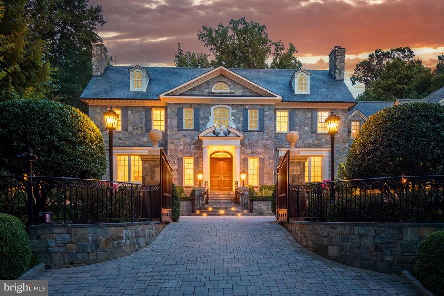 Extraordinary architecture by Harrison Design in this estate home nestled privately at the end of Turkey Run Road in an exclusive neighborhood surrounded by thousands of acres of parkland with hiking trails along the Potomac River. Iron gates open to a parking court leading to this handsomely sited stone residence built by Artisan builders with timeless in its design and finishes and features over 12,000 sf of living with 6 bedrooms, 7.5 baths, 6 fireplaces, a 4-car garage, screened porch with fireplace, pool, spa, and cabana with fireplace all surrounded by immaculate landscaping and hardscaping by Charles Owens of Fine Landscapes. Custom mahogany doors welcome guests into a reception hall with a pillow vaulted ceiling which opens into dramatic two-story music room with barrel vaulted ceiling with a two-story window offering amazing vistas of the pool and private backyard and gardens.
The entry hall opens to an elegant living room with an extraordinary limestone fireplace with a herringbone firebox and custom chimney breast mantle, an elegant dining room with connecting butler’s pantry and a wood paneled library with built-ins and scenic views. A gallery that is washed with sunlight from walls of windows connects the formal area to the family space. The informal area includes a spacious kitchen with a huge eat up center island, an abundance of classic cabinetry, professional appliances including a Lacanche range and Subzero refrigerator and a cozy breakfast room with corner stone gas fireplace. The adjoining family room with beamed ceiling and a stone gas fireplace is the perfect place to relax. The main level features 12 ft ceilings, and is complete with a wood paneled elevator, hobby room/mudroom with dog bath and laundry, two sets of stairs to the upper and lower levels and an oversized pantry. There is a separate entrance to private quarters over the garage.
On the upper level the owner’s suite has amazing vistas of the gardens and pool, a morning bar with beverage refrigerator, a 500 sf custom closet with two butler islands and a luxury bath with a stand-alone tub flanked by two art niches, seamless glass shower and his and her vanities. There are three additional generous en suites and a home office or study room with built-ins cabinets and desk.
The walkout and light filled lower level offers the ultimate space for entertaining with seamless flow to the expansive terrace with pool, spa, and pavilion with stone fireplace. Enjoy gatherings in the family room with coffered ceiling and stone gas fireplace that includes an adjoining billiards room with full equipped bar alcove. 1200 bottle temperature-controlled wine cellar with adjoining tasting room, fifth bedroom with full bath, fitness room with walls of windows with scenic views, a pool & exercise bath, a fully equipped media with snack bar and front and back stairs. This home is equipped with a whole house generator. Designed for both comfortable daily living and elegant entertaining, this elegant residence provides a timeless destination in one of the best locations in the Washington area.