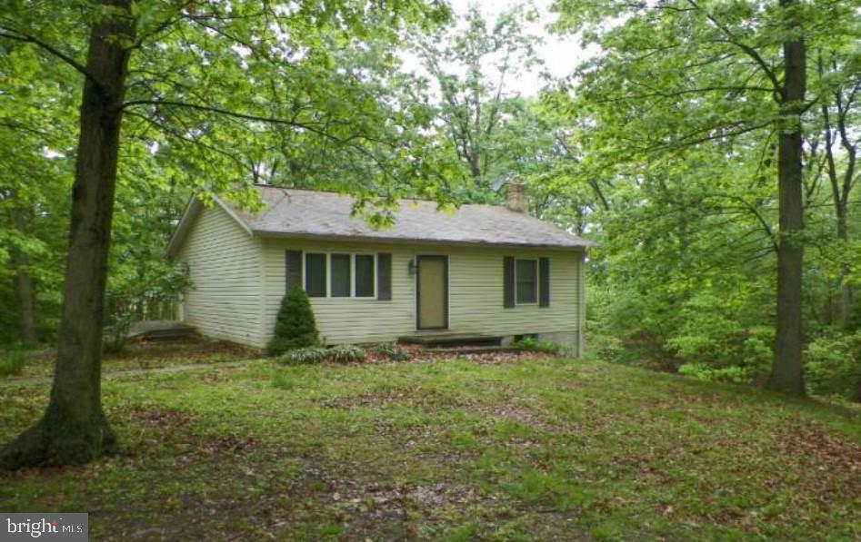 Tucked away on a serene 2-acre lot in Hedgesville, 136 Getaway Road offers a peaceful blend of privacy, simplicity, and natural beauty. This charming 2-bedroom, 1-bath home is perfect as a full-time residence or weekend retreat for those seeking a slower pace and quiet surroundings.
Set among mature trees and open space, the property offers plenty of room to roam and unwind. A large rear deck provides the ideal spot to enjoy the outdoors—whether you're taking in the wooded views, dining al fresco, or simply relaxing in the fresh air. Inside, the home offers a comfortable and functional layout with a relaxed atmosphere that suits a variety of needs and lifestyles.
Conveniently located just a short drive from Sleepy Creek Wildlife Management Area, Cacapon Resort State Park, and the shops and restaurants of Berkeley Springs, this home also provides easy access to Martinsburg, I-81, and Winchester. Washington, D.C. and Dulles International Airport are within a two-hour drive, making it a manageable escape from the city. With no HOA and plenty of room to spread out, 136 Getaway Road is your opportunity to enjoy the simple beauty of West Virginia living.